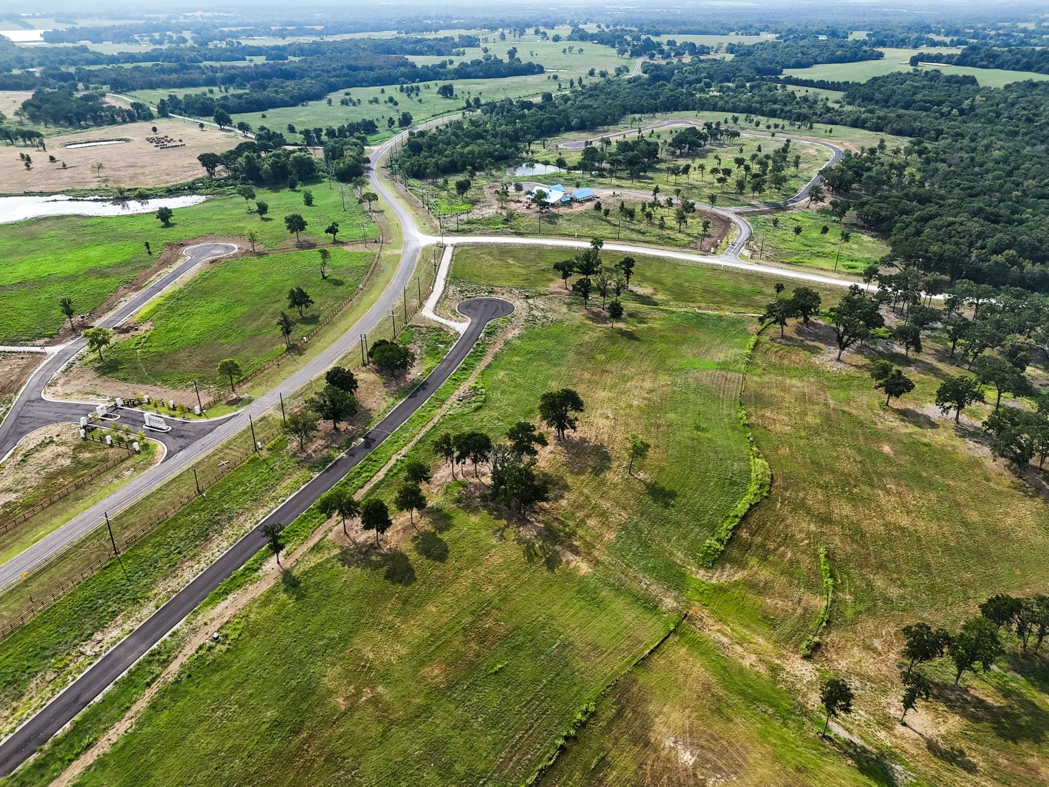 Aerial overview of property's location with a large body of water and rural landscape