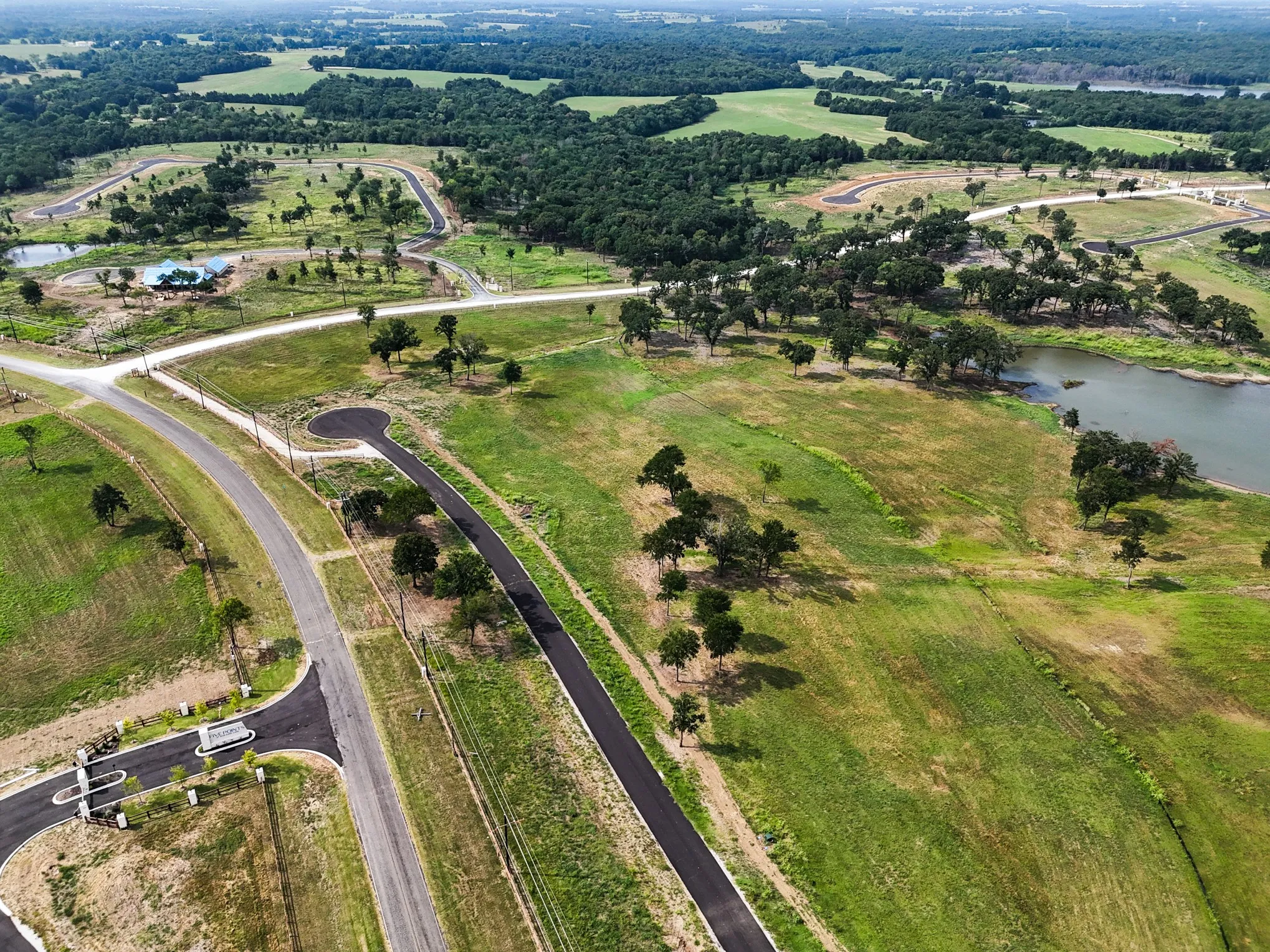 Aerial view of property and surrounding area with a large body of water and rural landscape