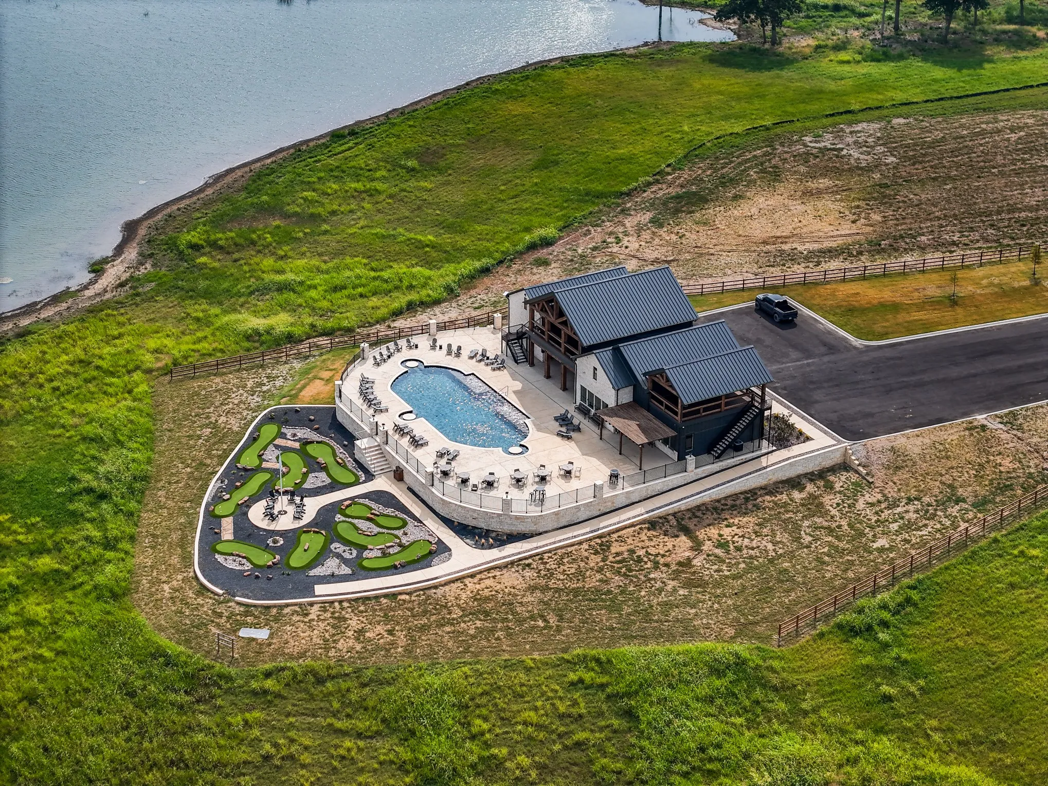 View from above of property featuring a pool and a nearby body of water