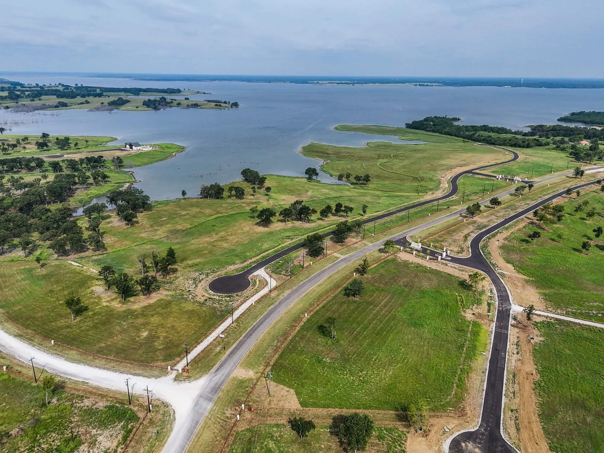 Aerial view of property's location with a large body of water