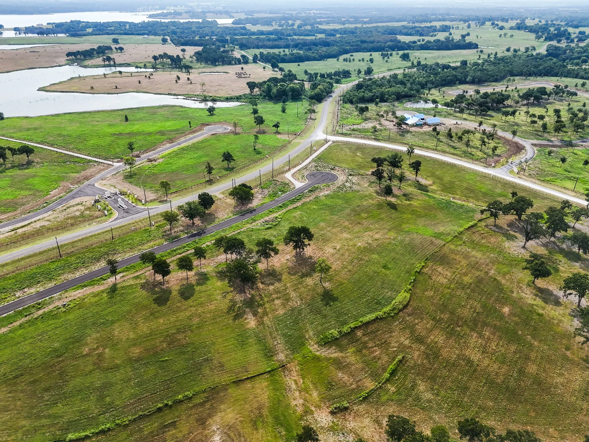 Aerial overview of property's location featuring a large body of water and rural landscape