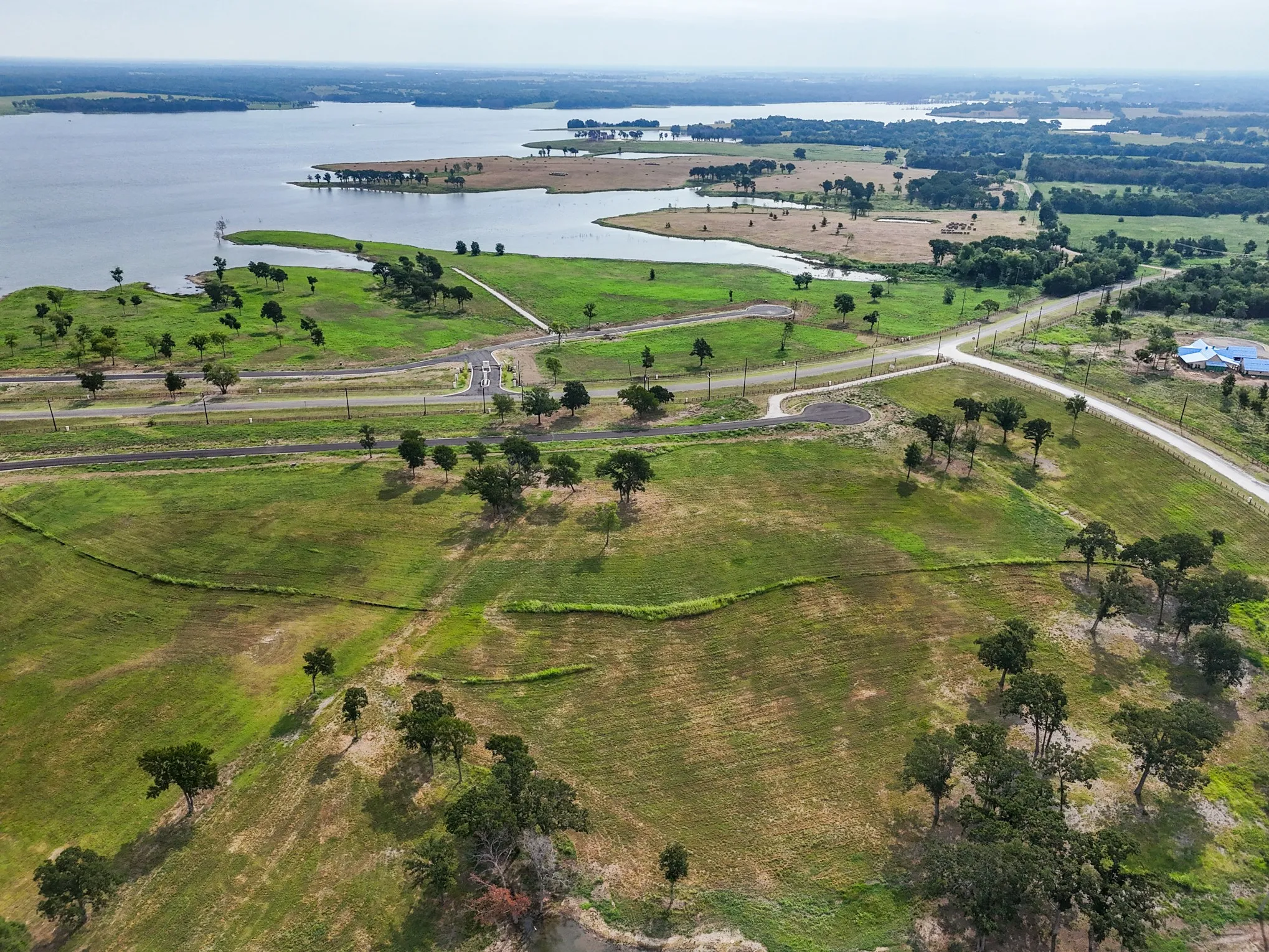 Aerial view of property and surrounding area with a nearby body of water