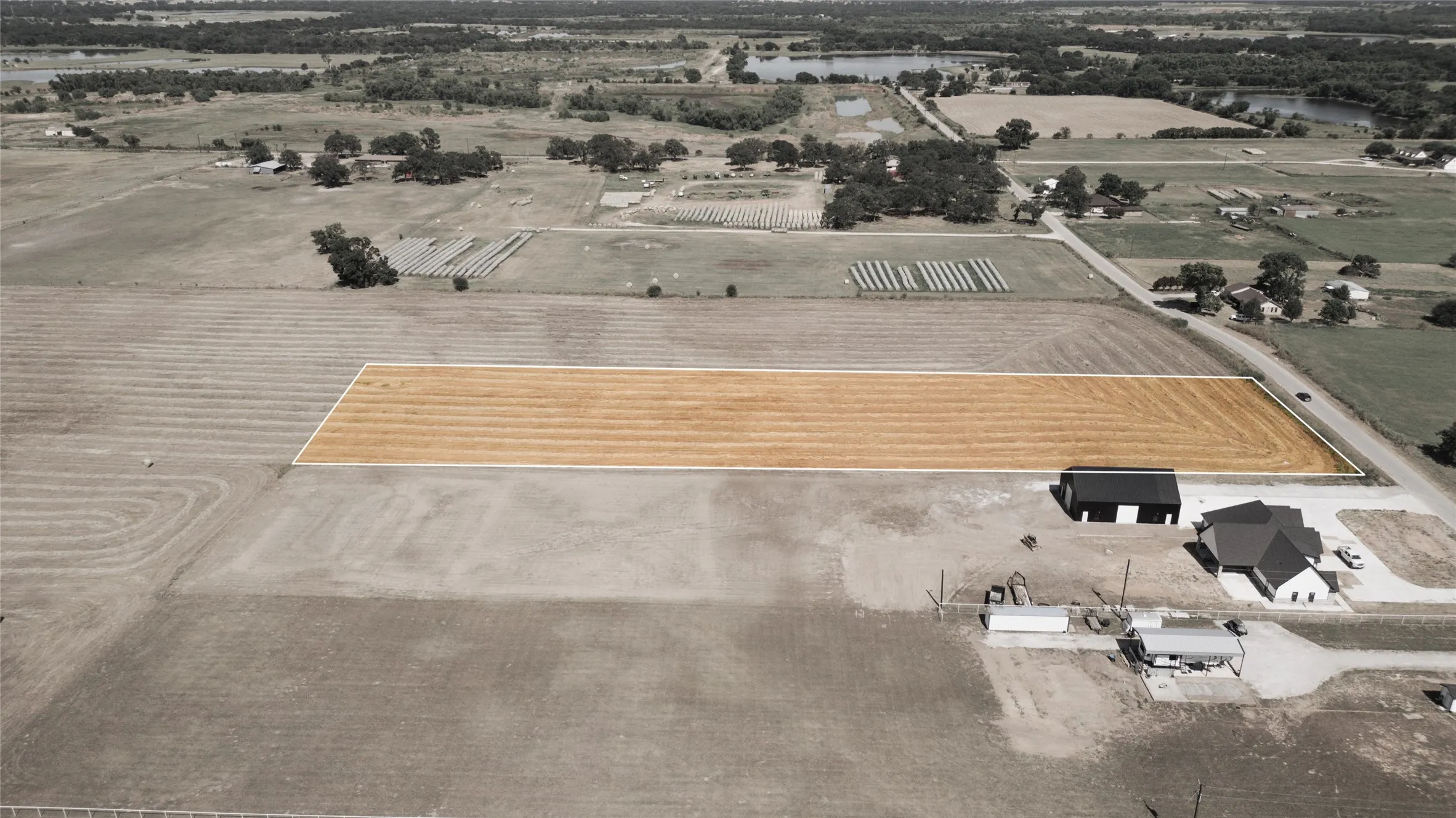 Aerial view of property's location with a nearby body of water and rural landscape