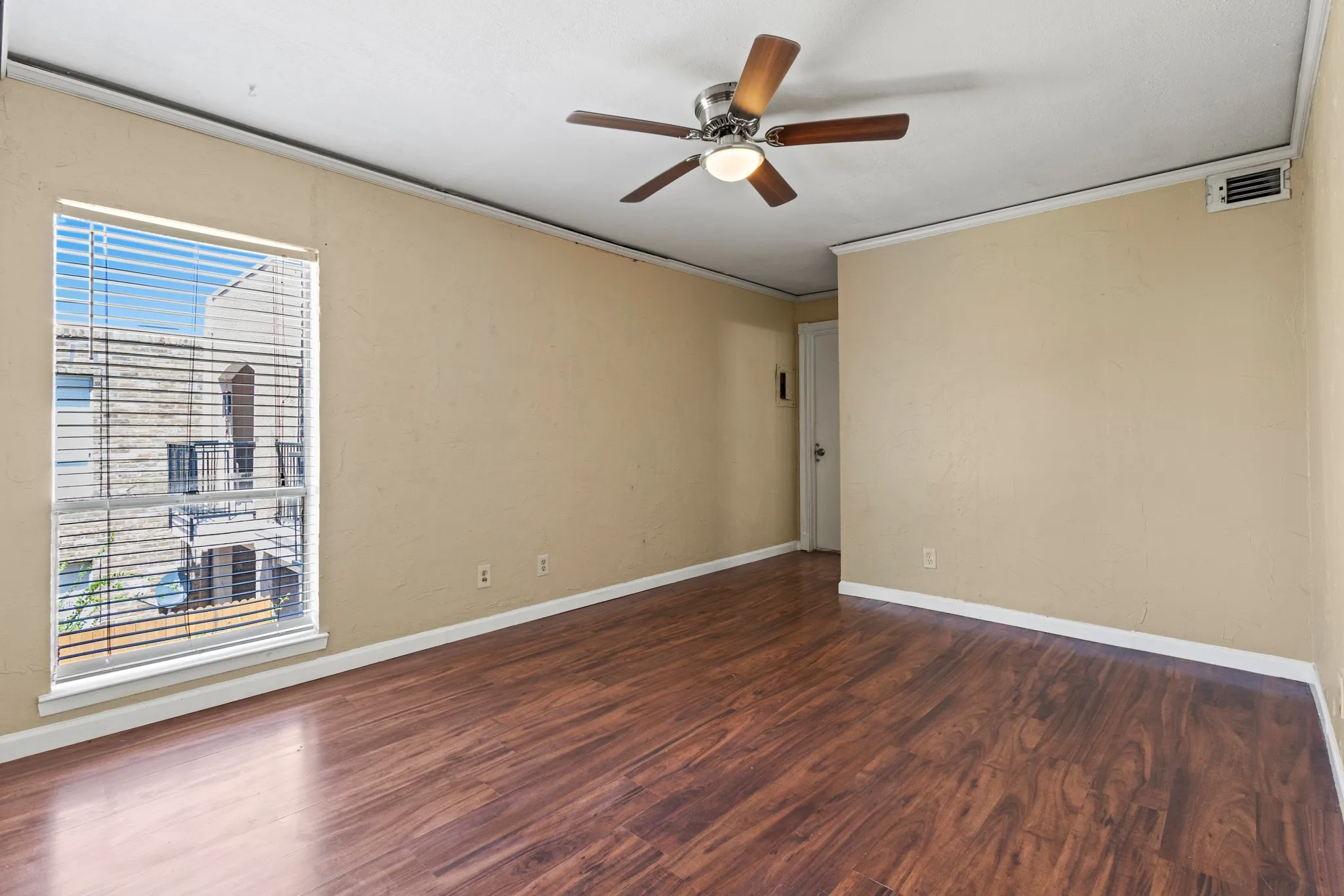 Unfurnished room with wood finished floors, crown molding, and a ceiling fan