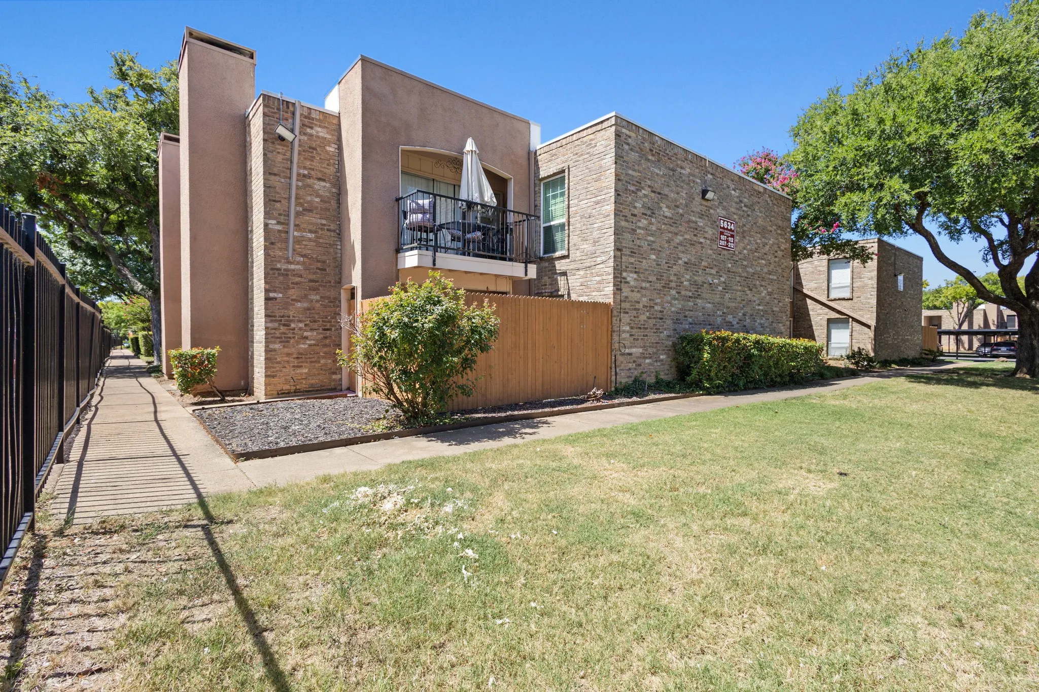 View of property exterior featuring stucco siding and brick siding