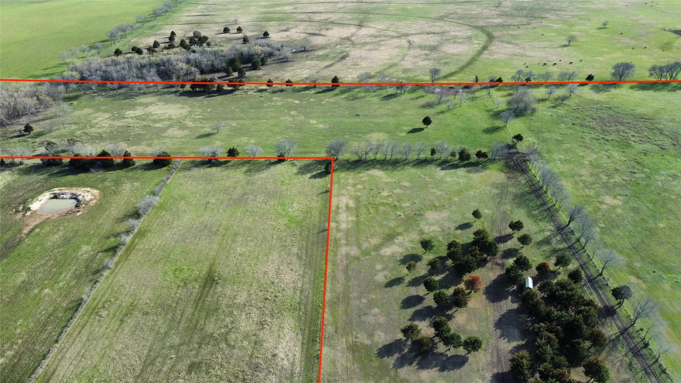 Aerial view of sparsely populated area featuring property parcel outlined