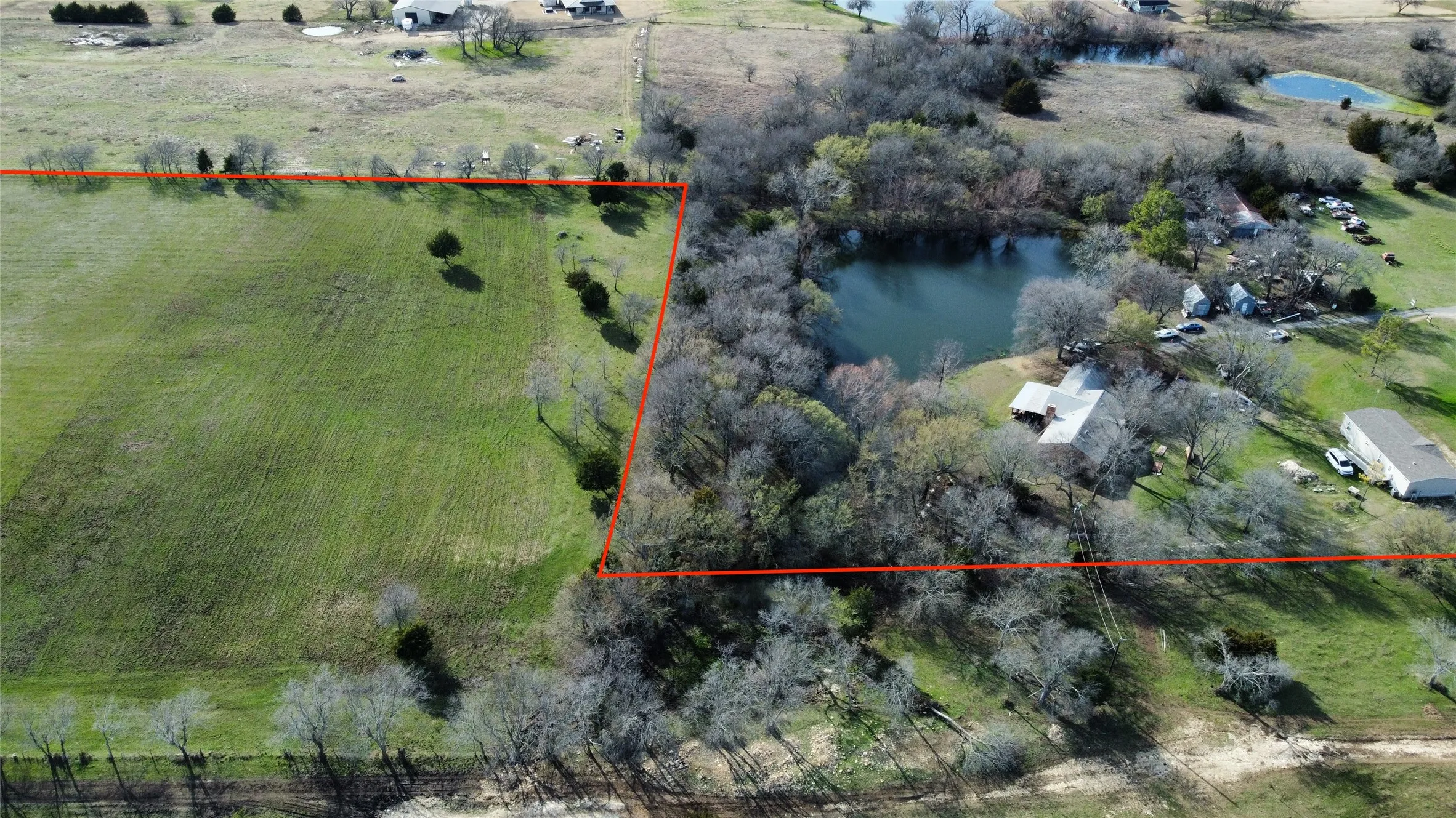 Overview of rural landscape featuring a nearby body of water and property boundaries highlighted
