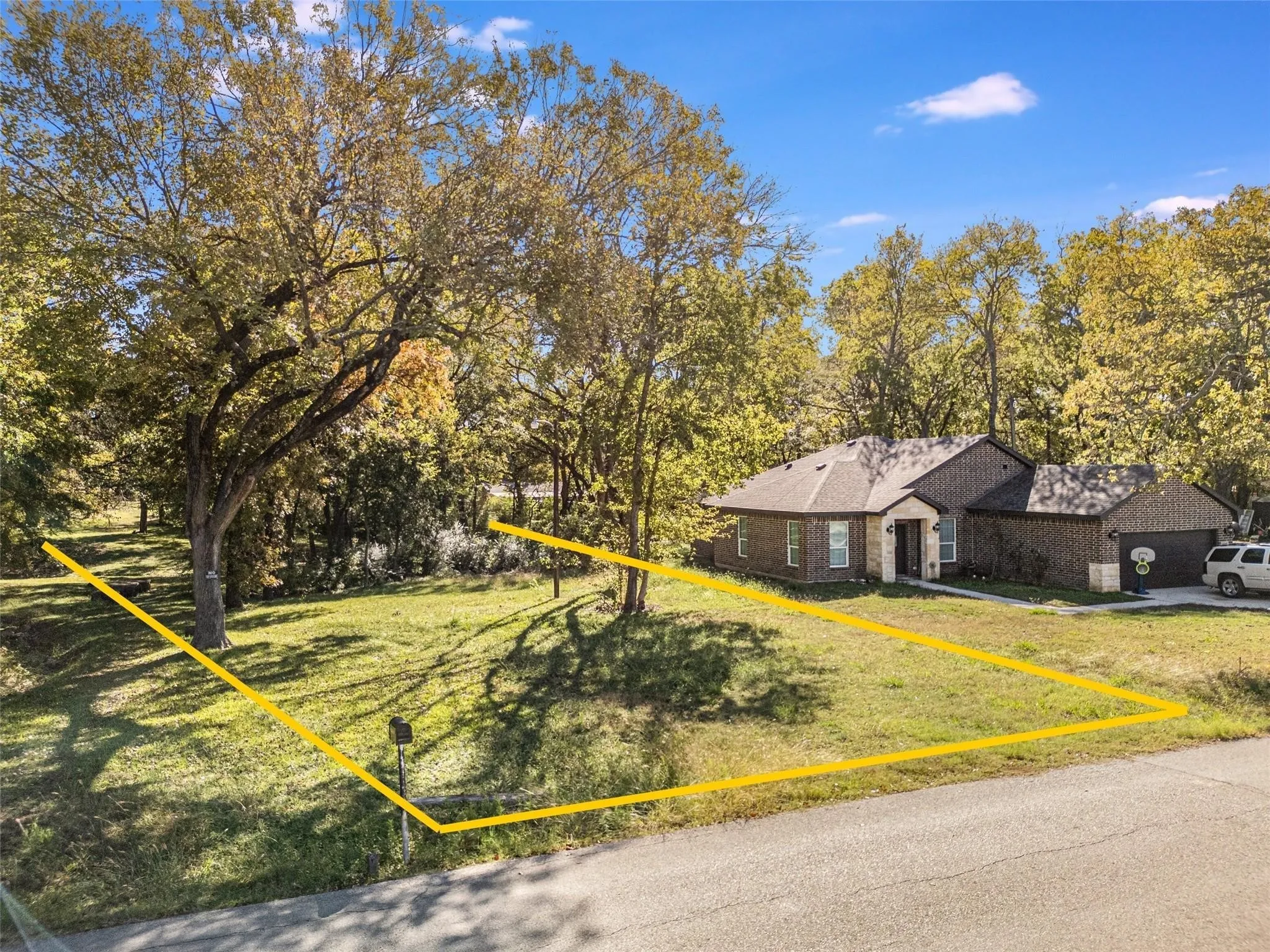View of front of house featuring a front yard, brick siding, and a garage