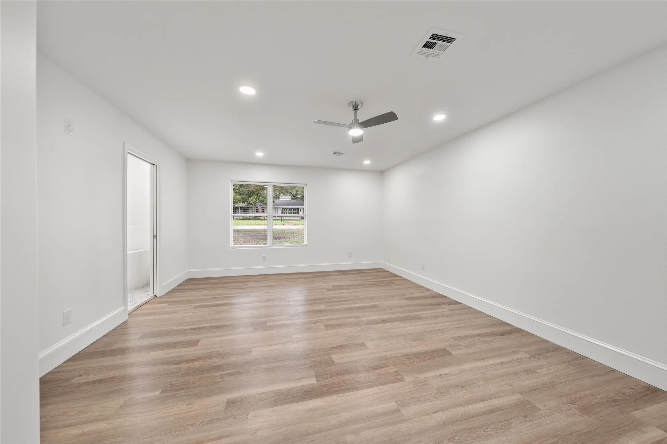 Empty room with recessed lighting, light wood-type flooring, and a ceiling fan