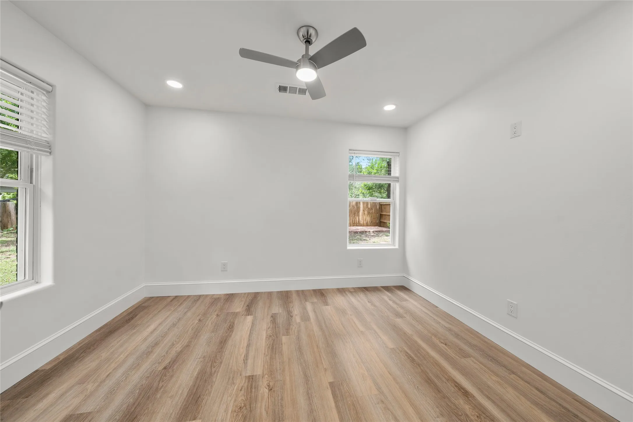 Empty room with light wood-style floors, recessed lighting, and ceiling fan