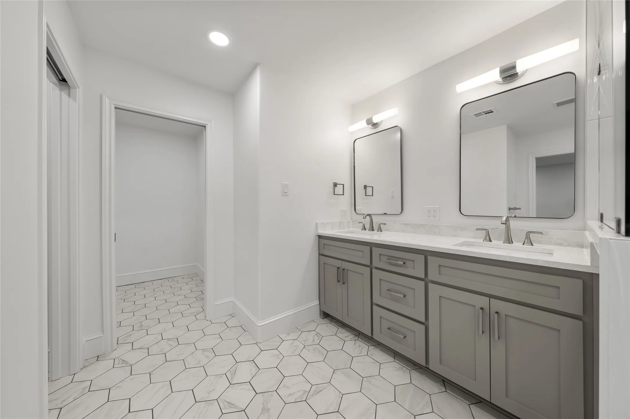 Full bathroom featuring double vanity and recessed lighting