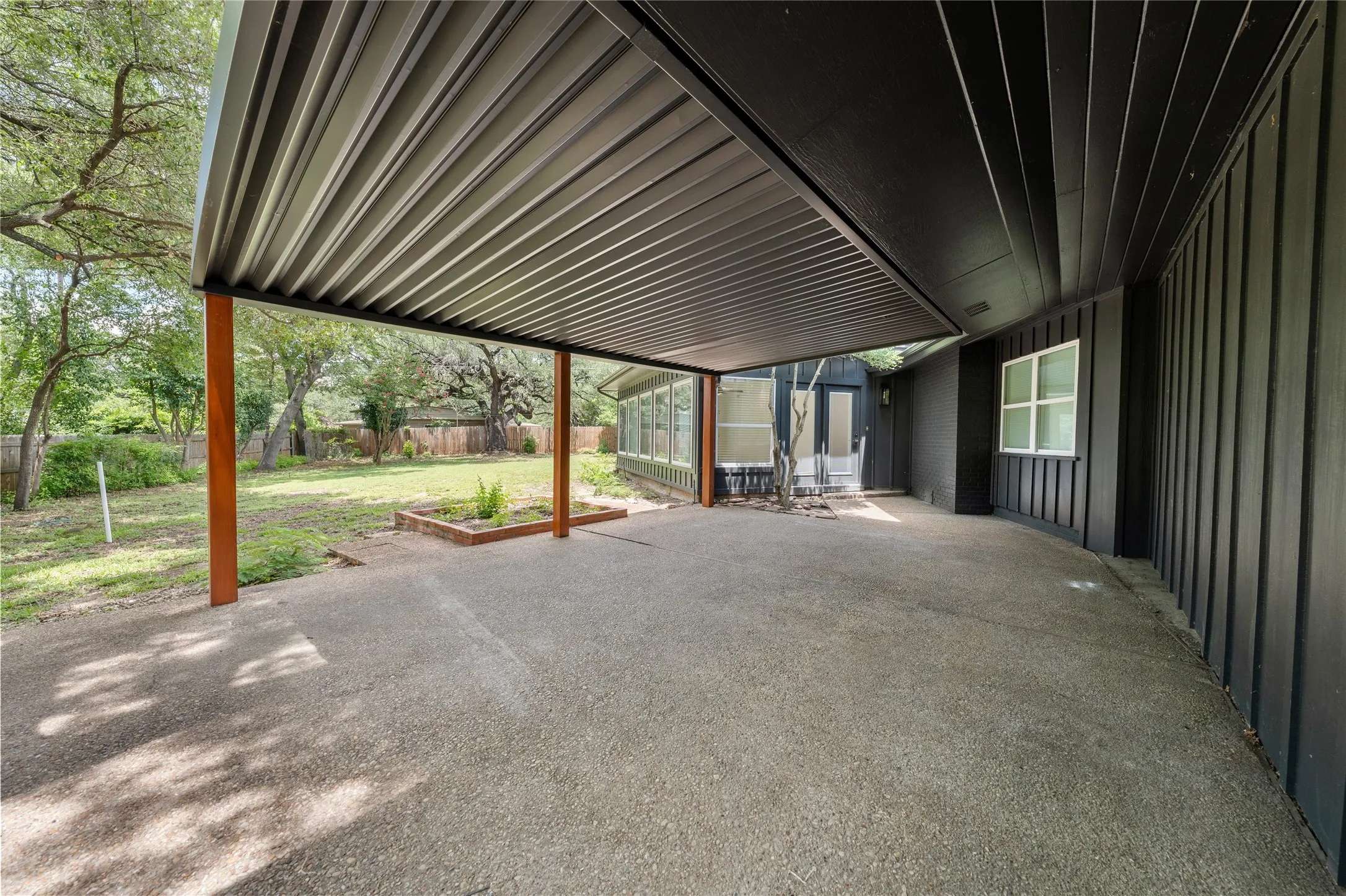 Fenced backyard with a patio area