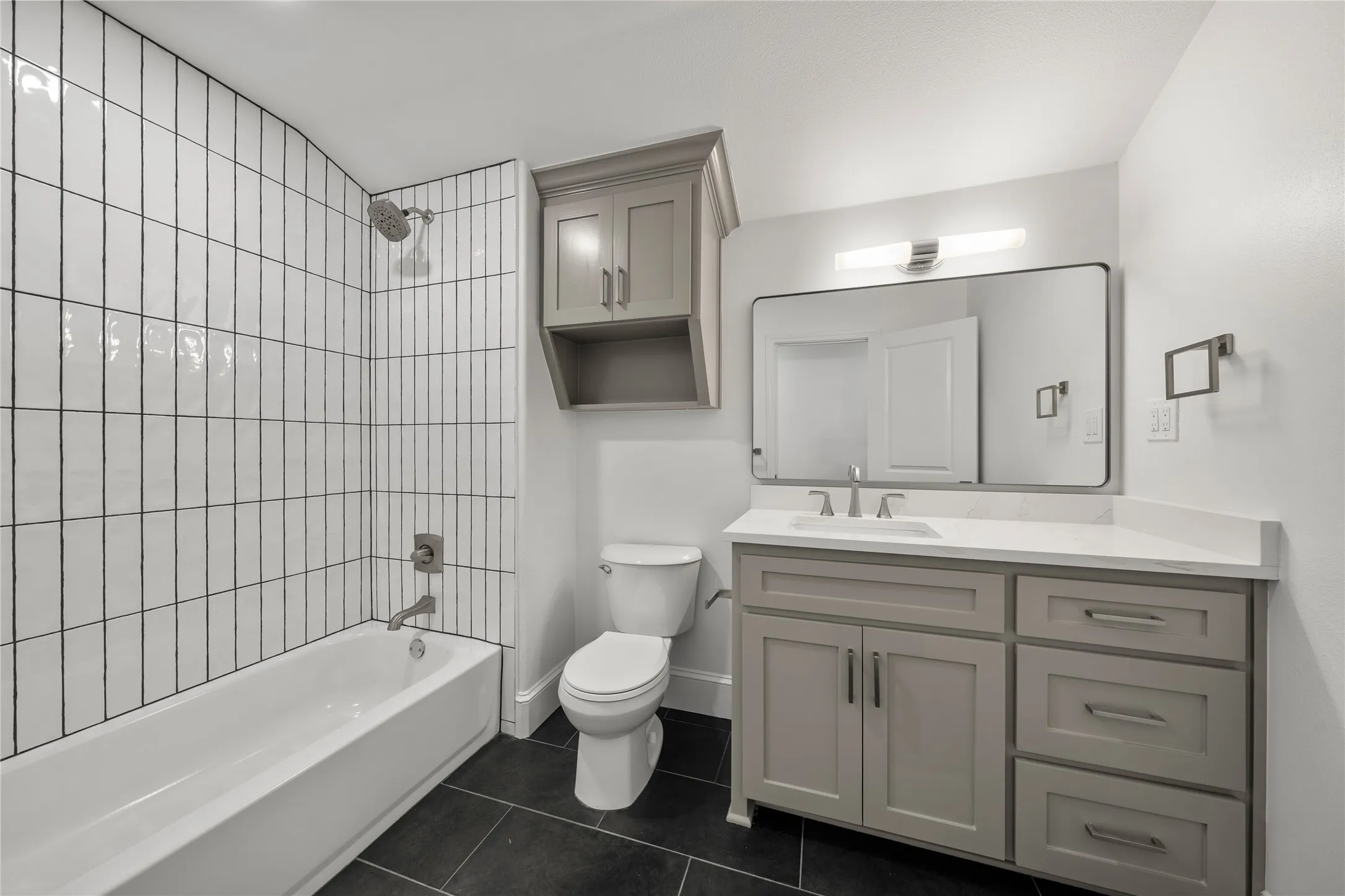 Bathroom featuring vanity, shower / bath combination, and tile patterned floors