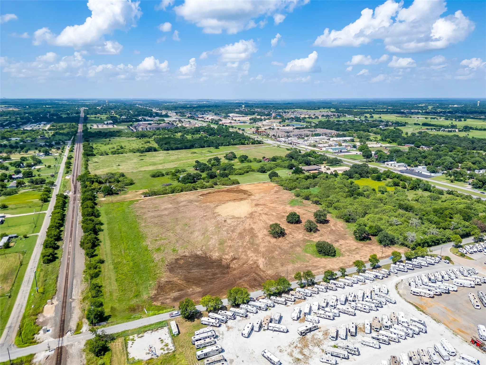 Drone / aerial view of a tree filled landscape and a marina