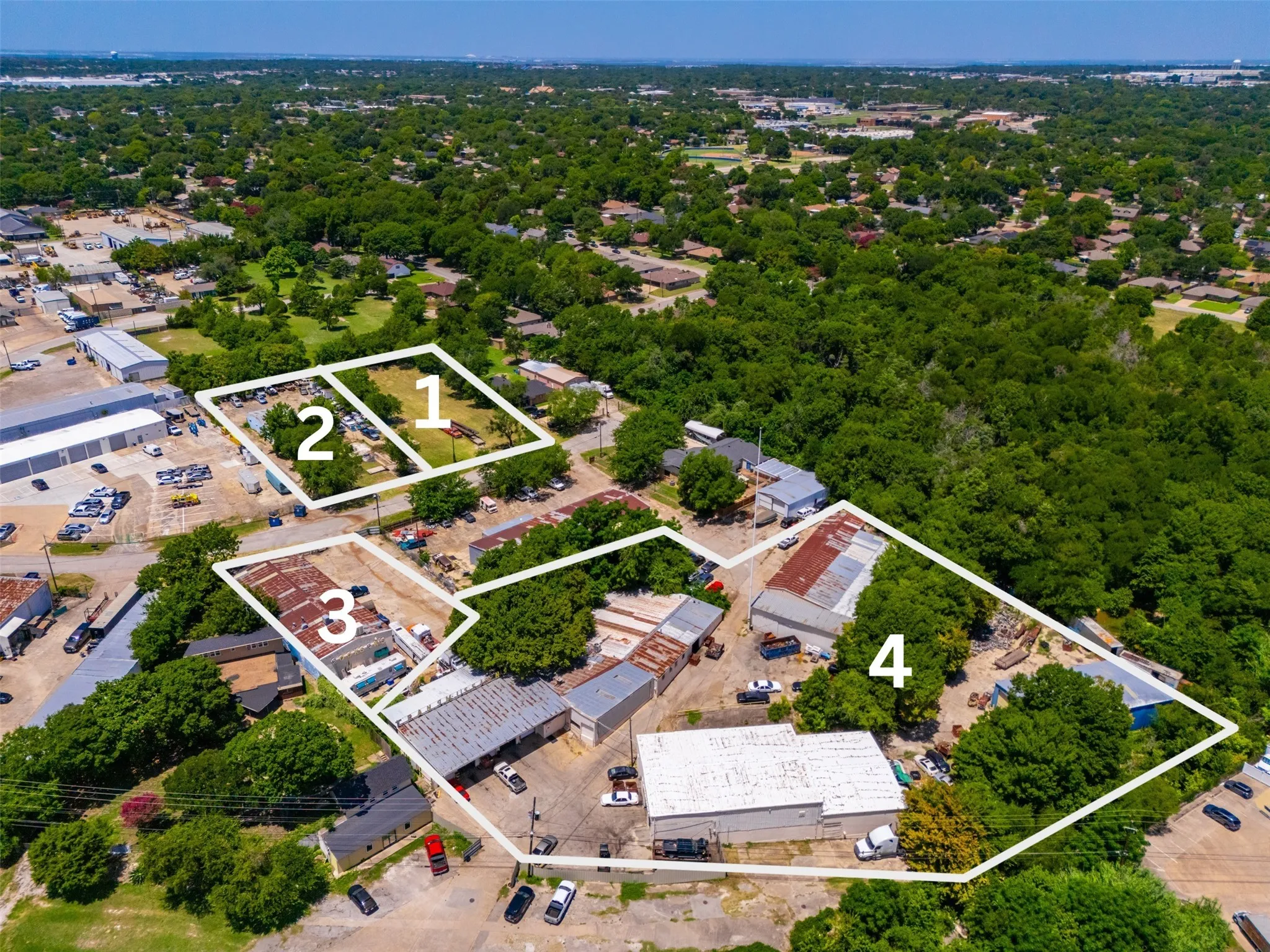 Aerial perspective showcasing multiple parcels of land with varied development