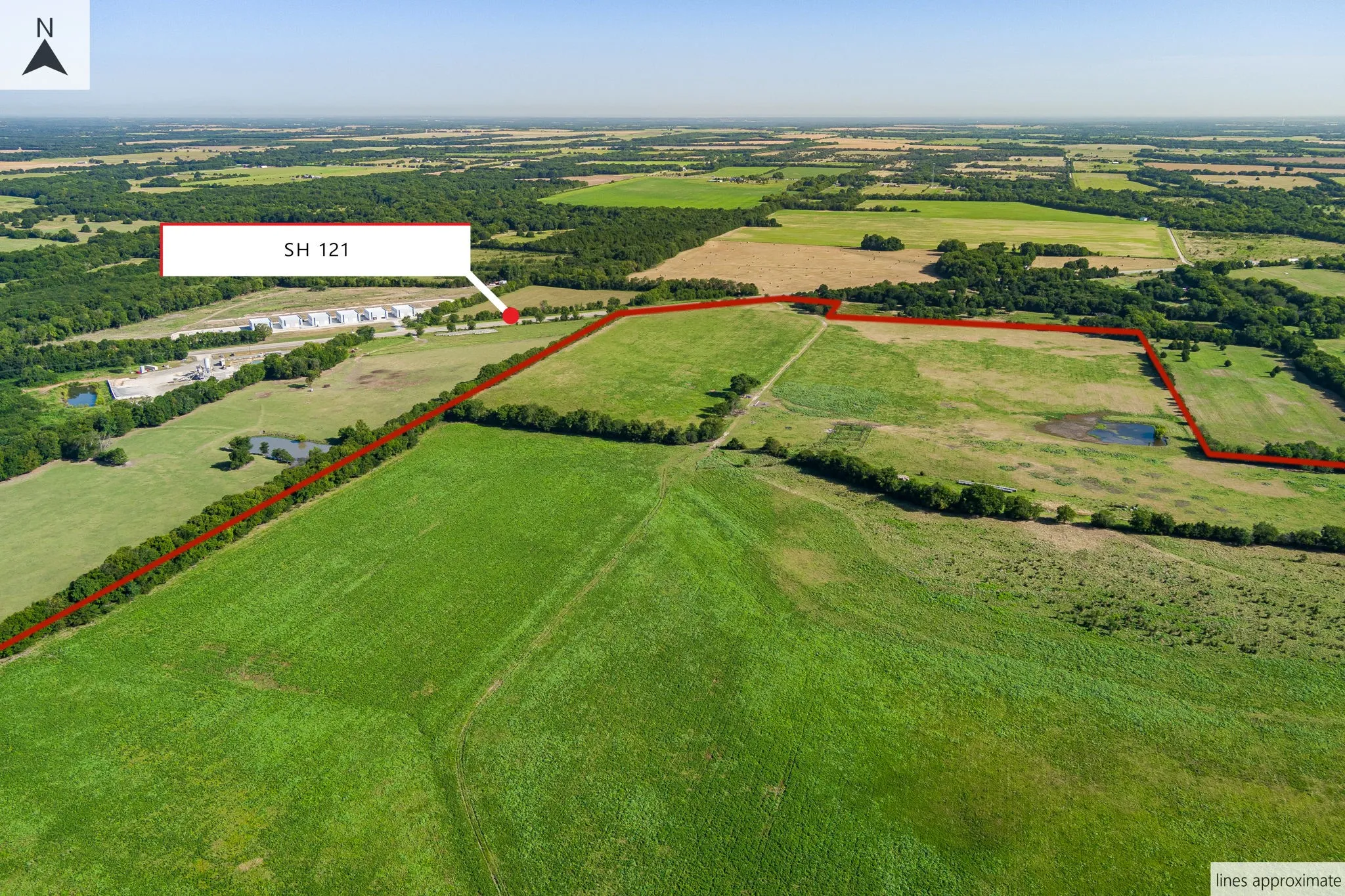 Aerial view of sparsely populated area featuring property parcel outlined and a nearby body of water