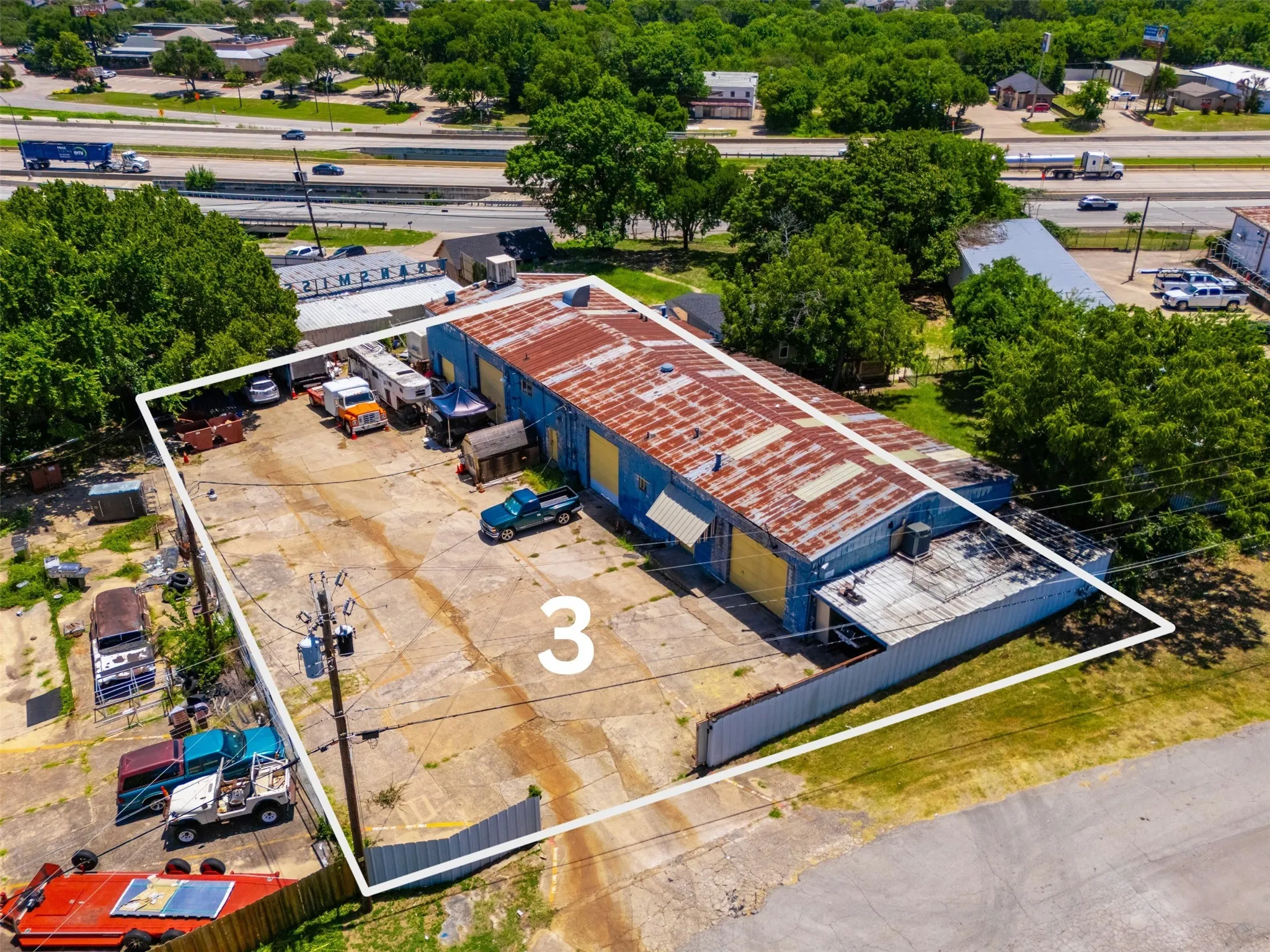 Commercial property featuring a large blue structure with a corrugated metal roof