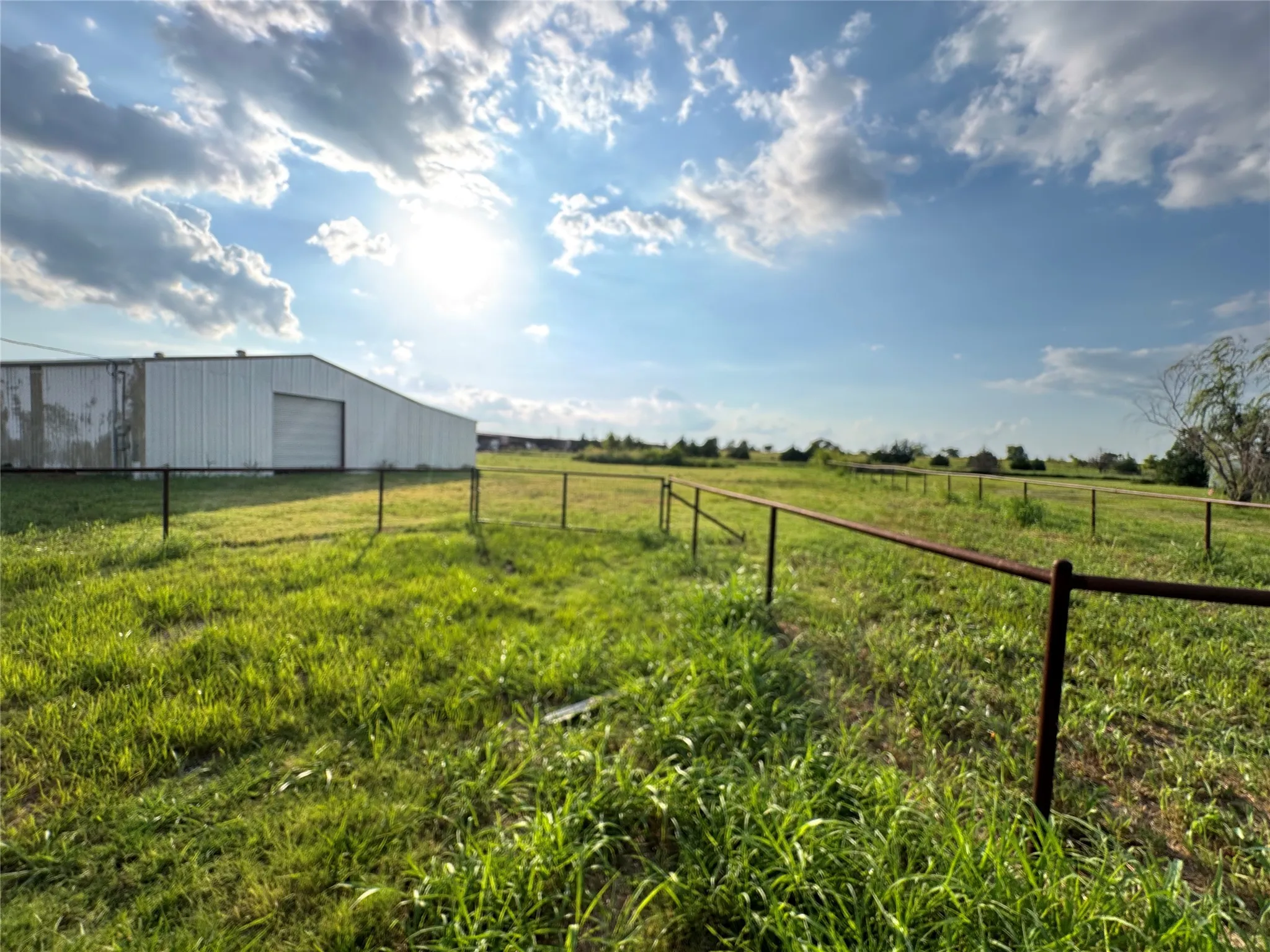 View of yard with an outbuilding, a view of rural / pastoral area, and a garage