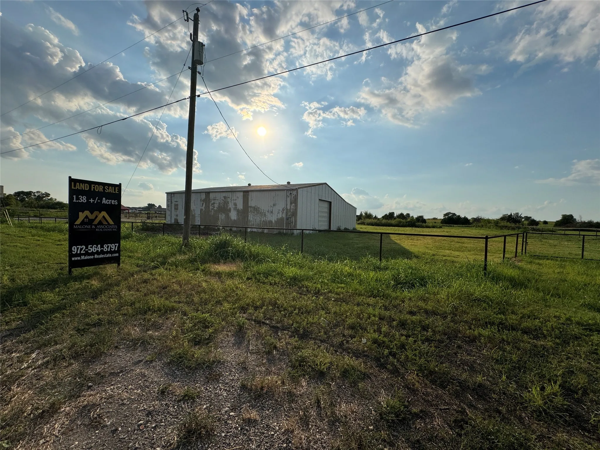 View of yard with a pole building, a view of countryside, and an outdoor structure