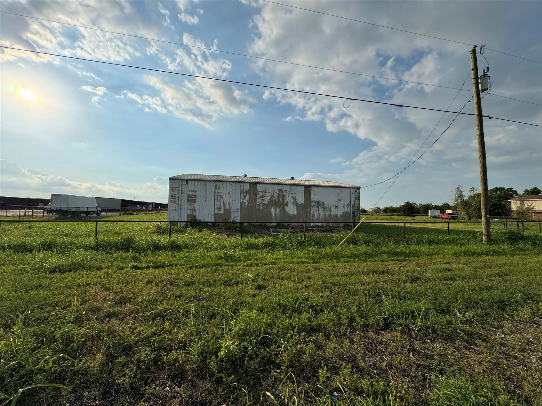 View of yard featuring a pole building, an outdoor structure, and a rural view