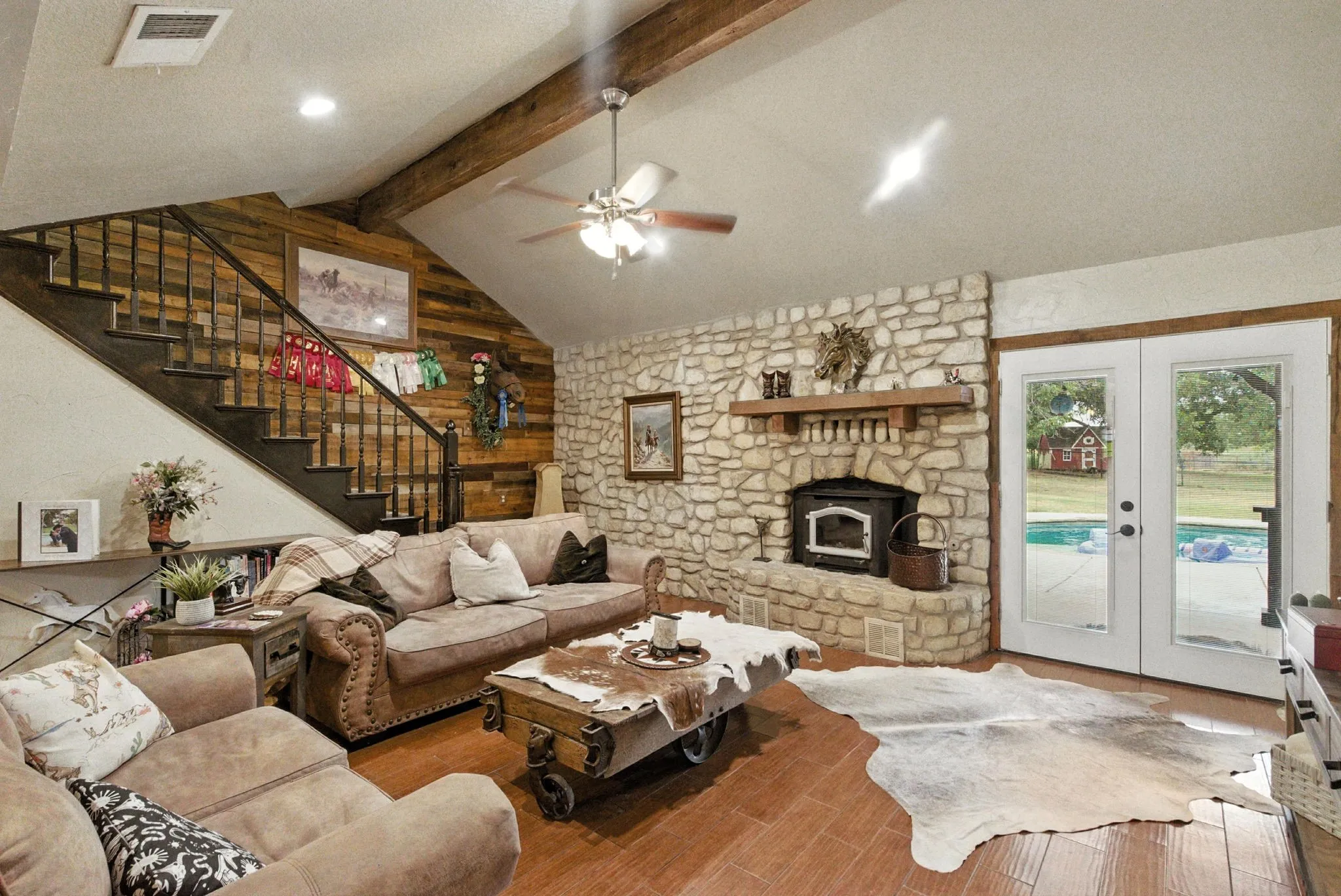 Living room featuring stairway, wood finished floors, french doors, a textured ceiling, and ceiling fan