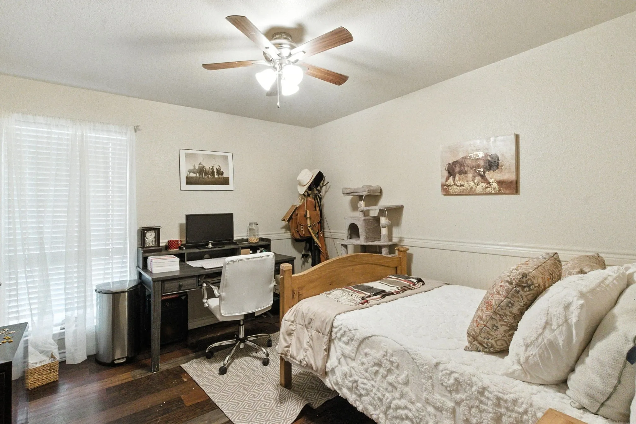 Bedroom featuring dark wood-style flooring, a desk, and a ceiling fan