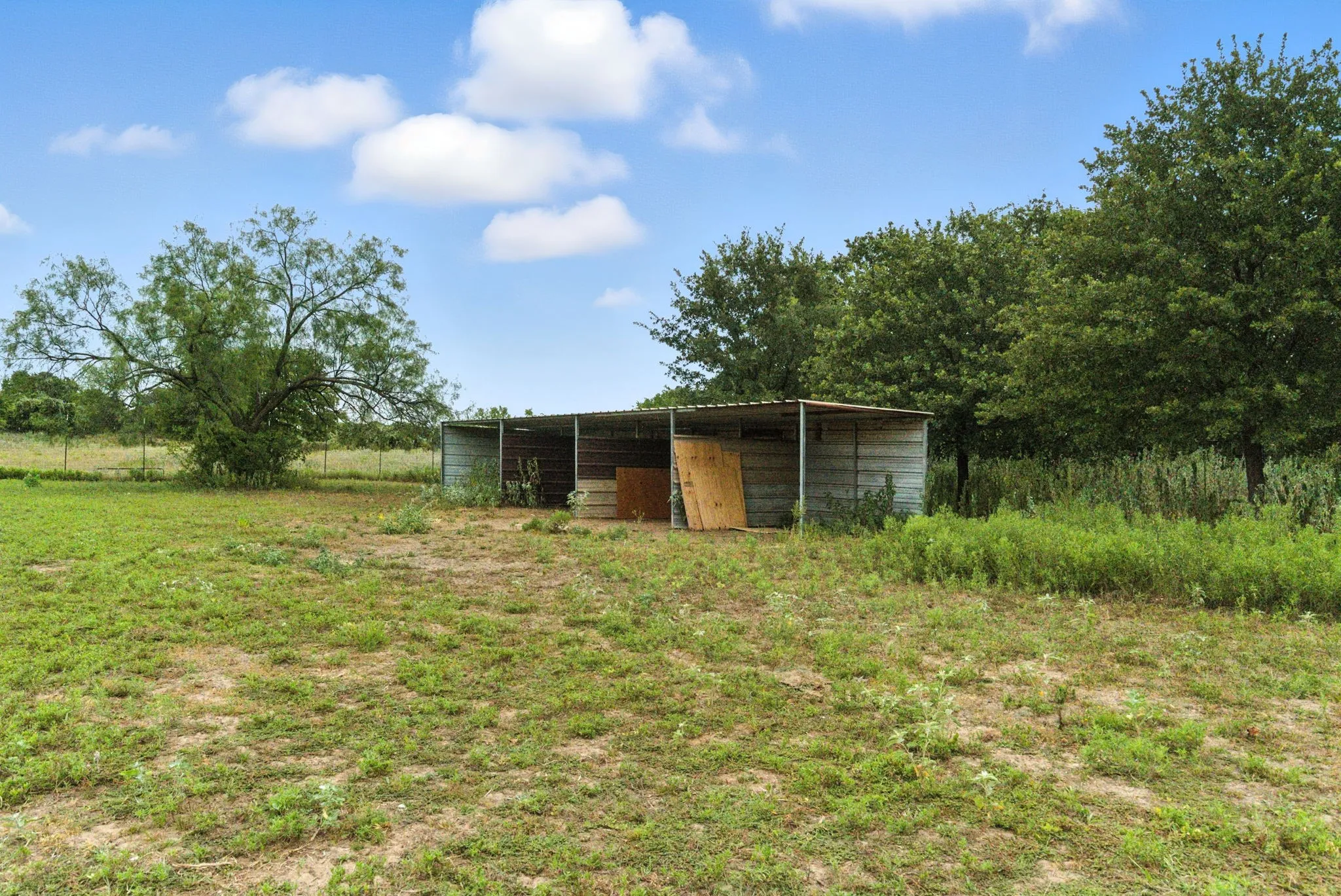 View of pole building with a rural view