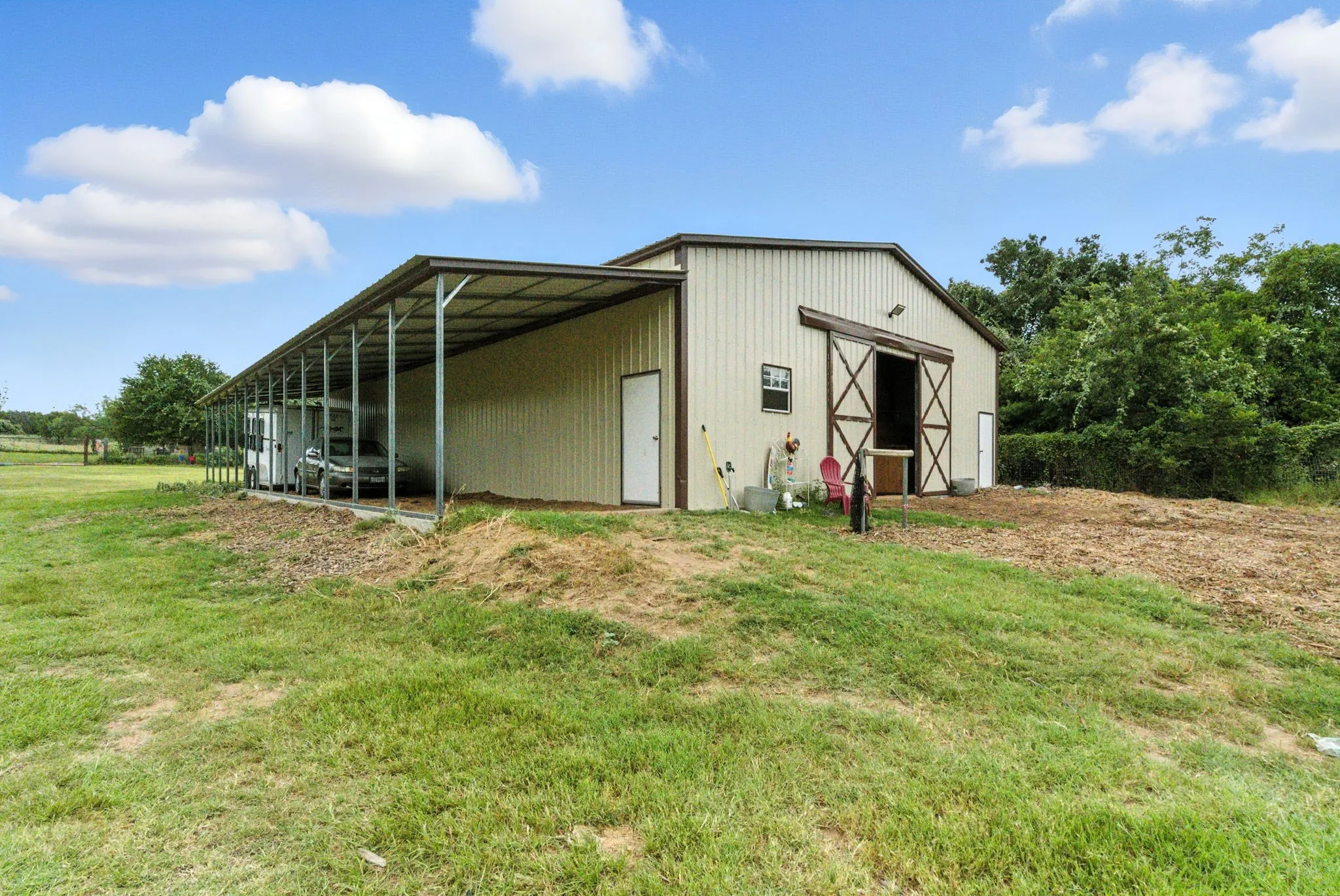 View of pole building featuring a lawn
