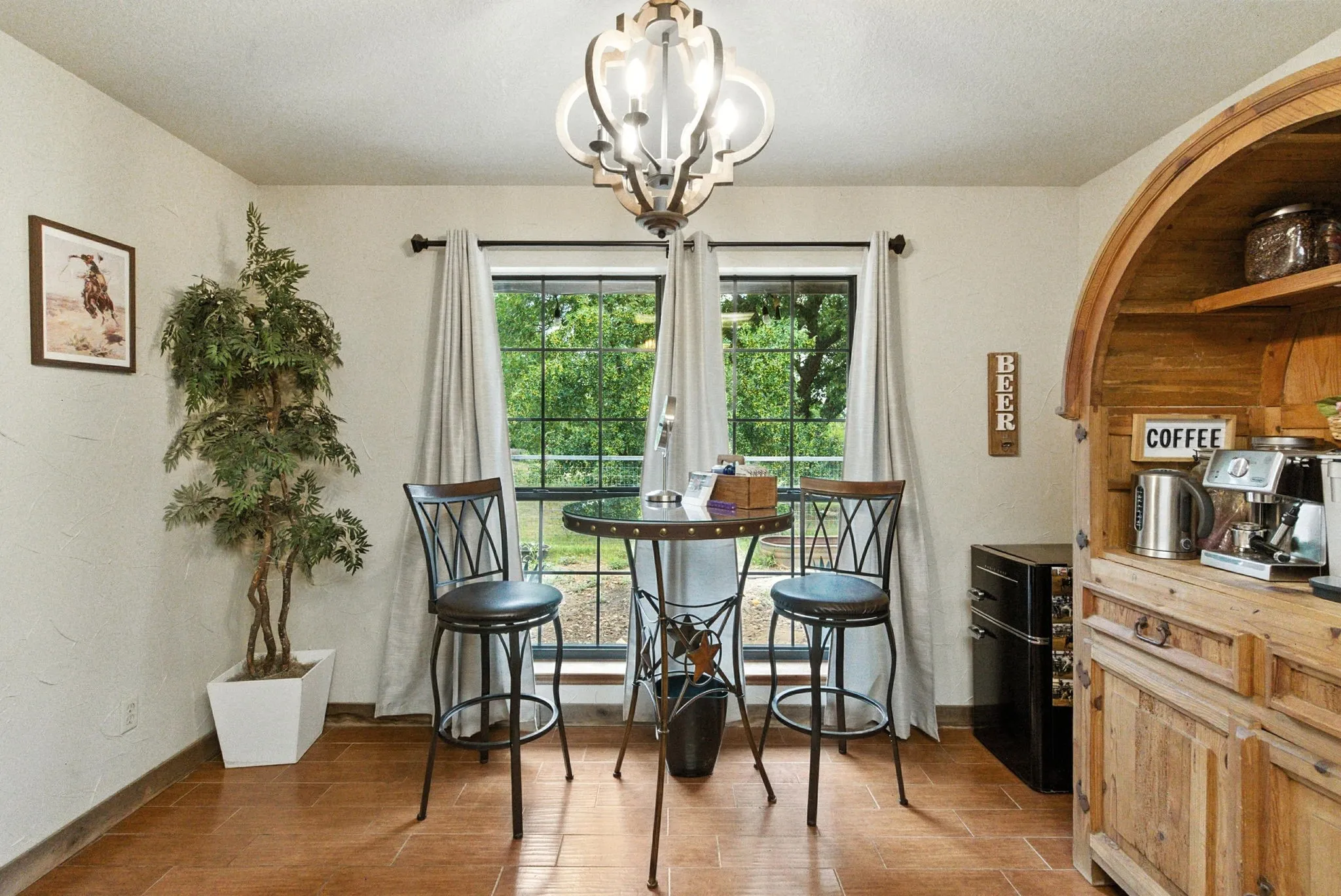 Dining area featuring wood finished floors and a chandelier