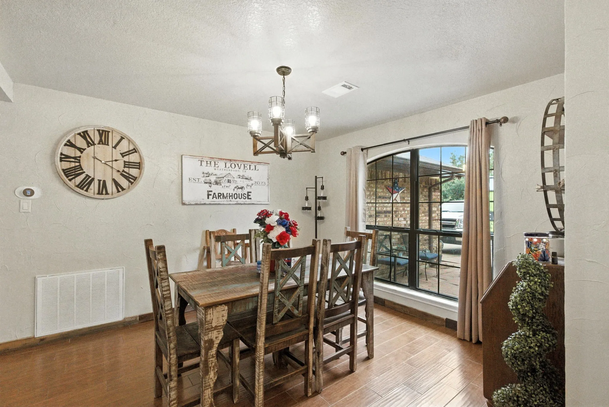 Dining space featuring a textured ceiling, wood finished floors, and a chandelier