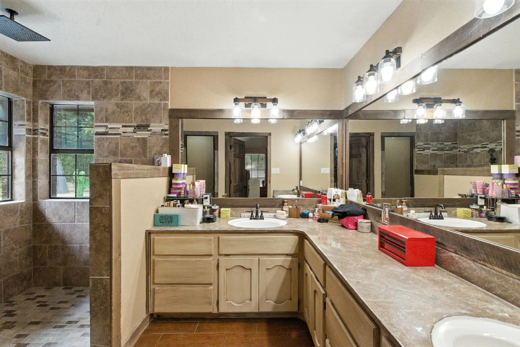 Full bathroom with a walk in shower, double vanity, and tile patterned flooring