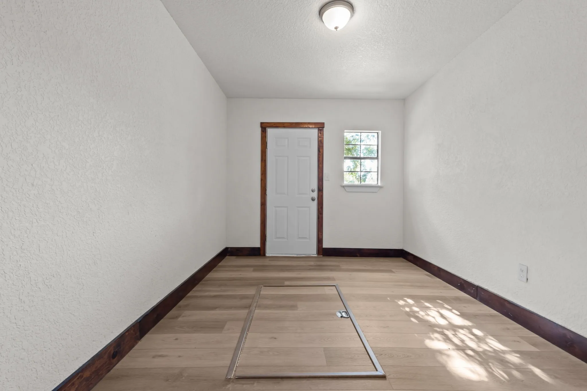 Storage room or perfect primary walk-in closet with storm cellar
