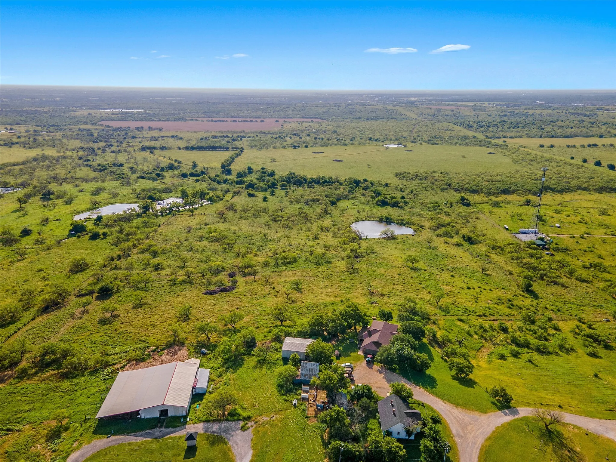 Aerial view of property's location featuring a large body of water and rural landscape