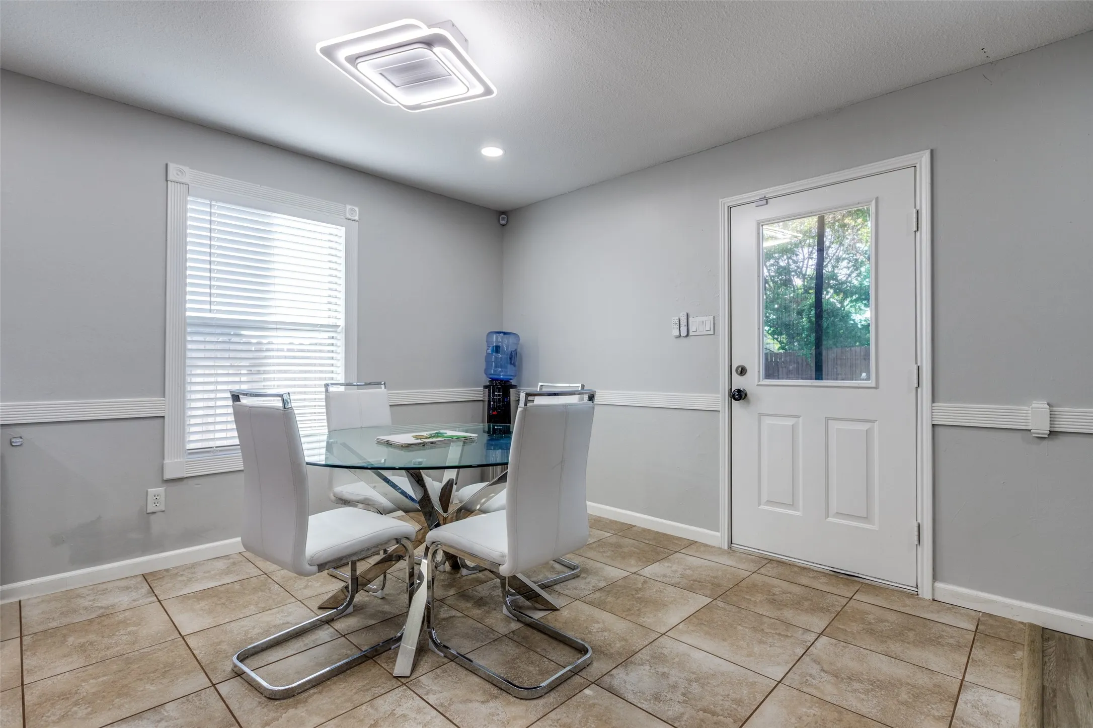 Dining room with tile patterned floors and recessed lighting