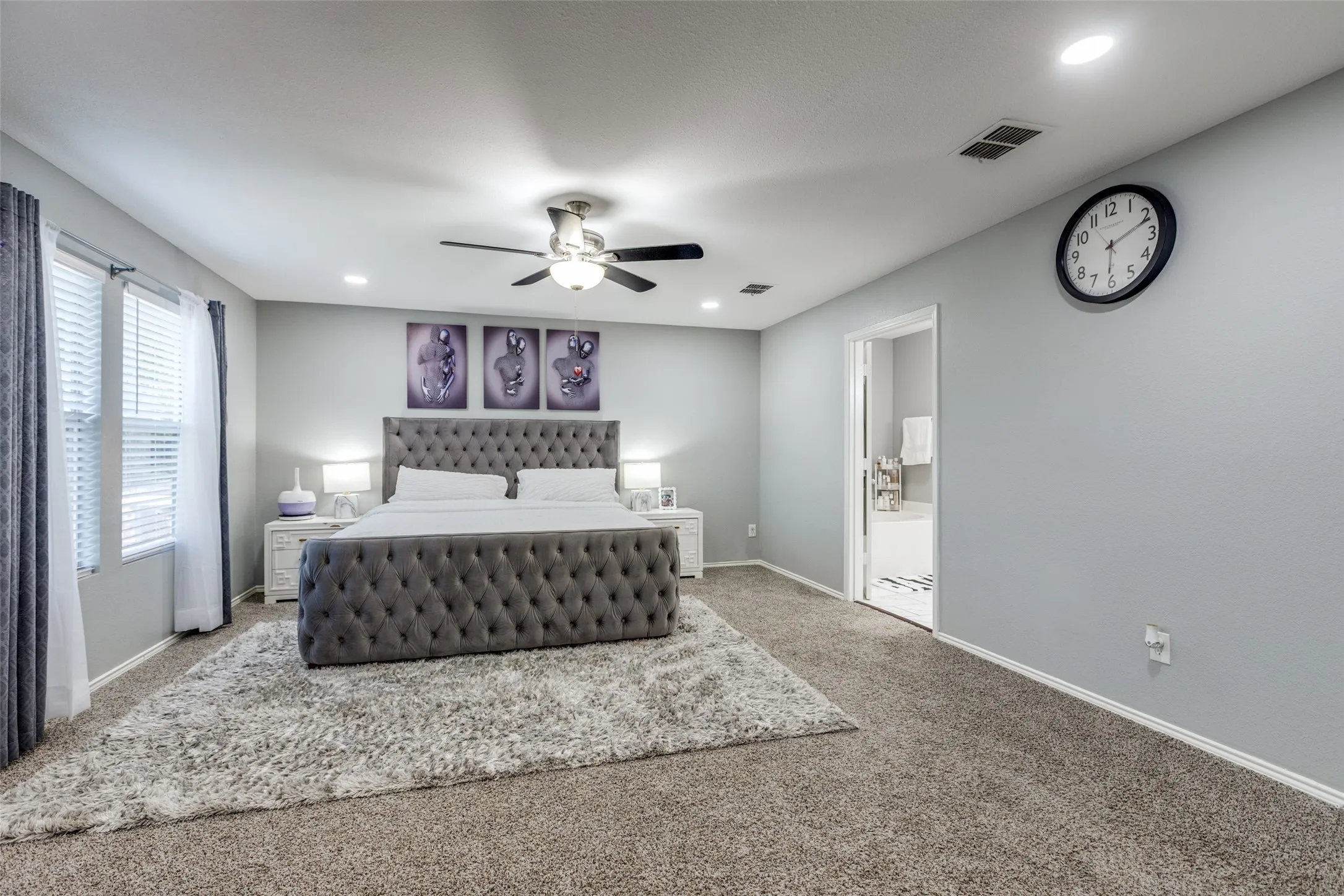 Carpeted bedroom featuring recessed lighting, ensuite bathroom, and a ceiling fan