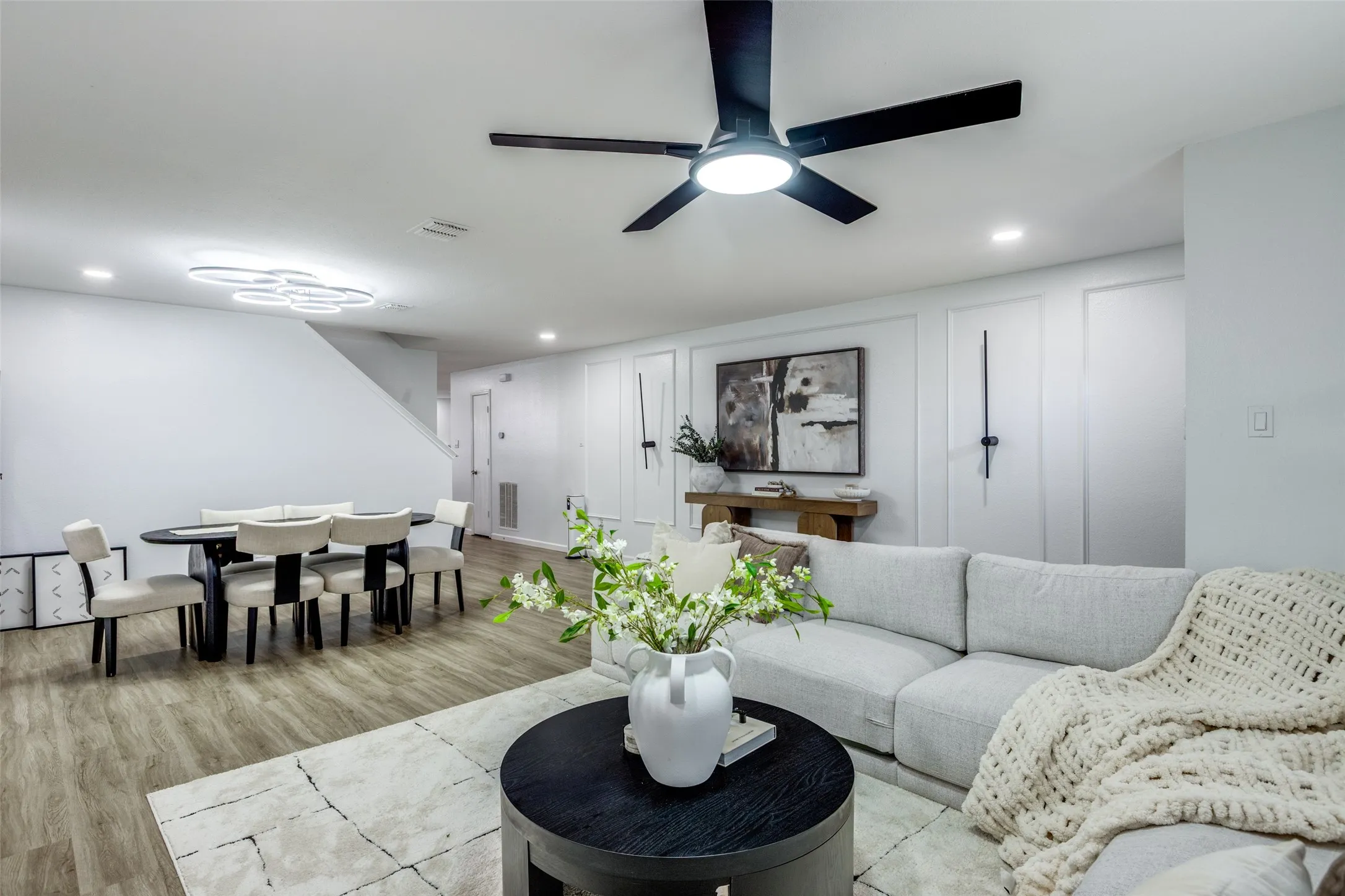 Living area with recessed lighting, wood finished floors, and ceiling fan