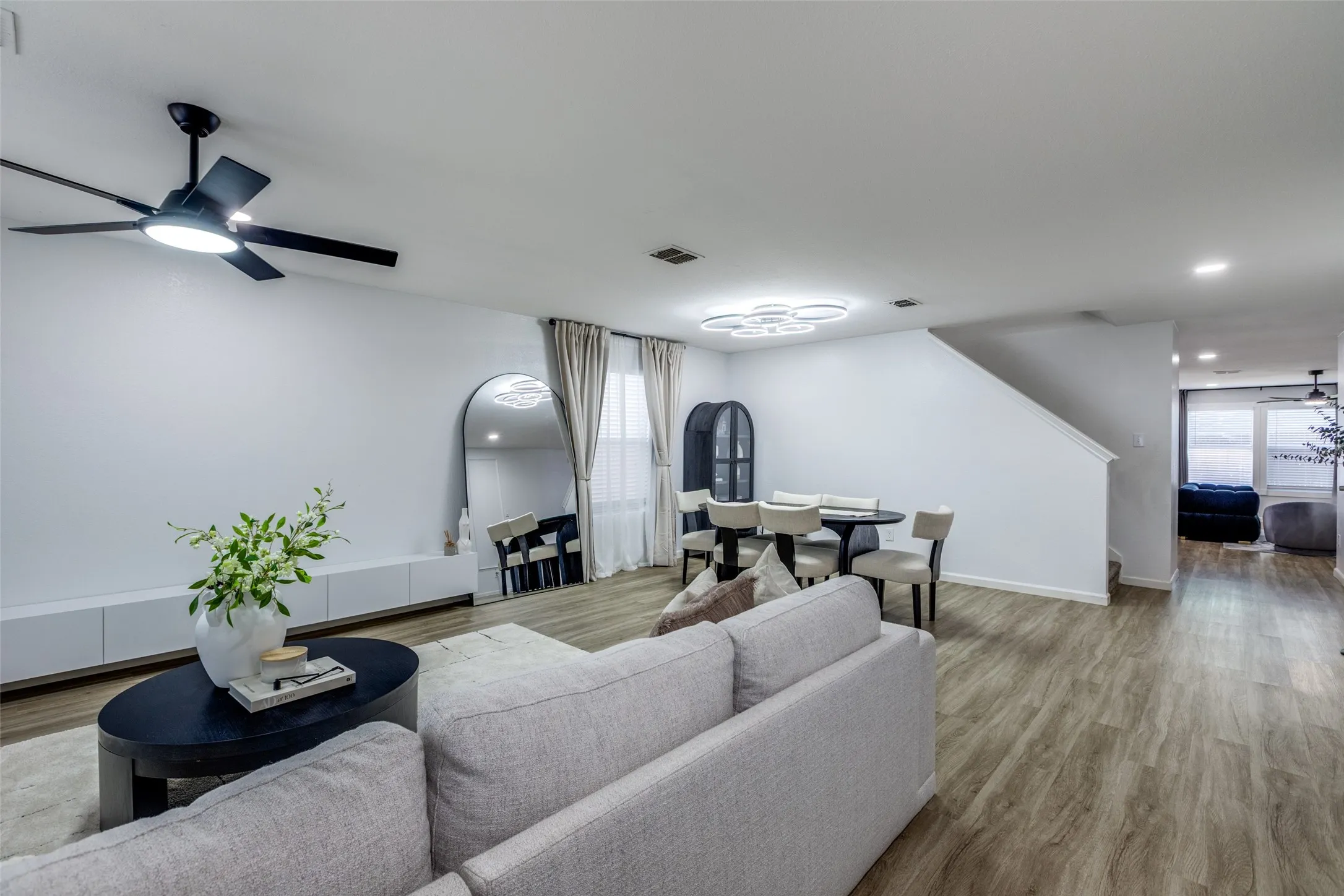 Living room with ceiling fan, wood finished floors, and recessed lighting