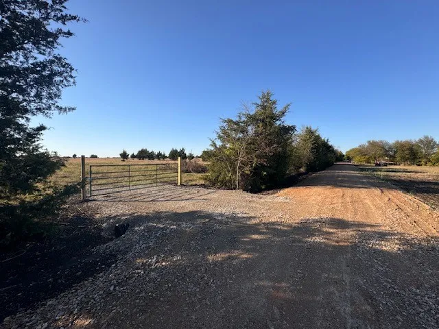 View of dirt / gravel road with a view of countryside