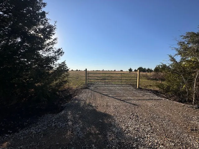View of yard with a view of countryside and a gate