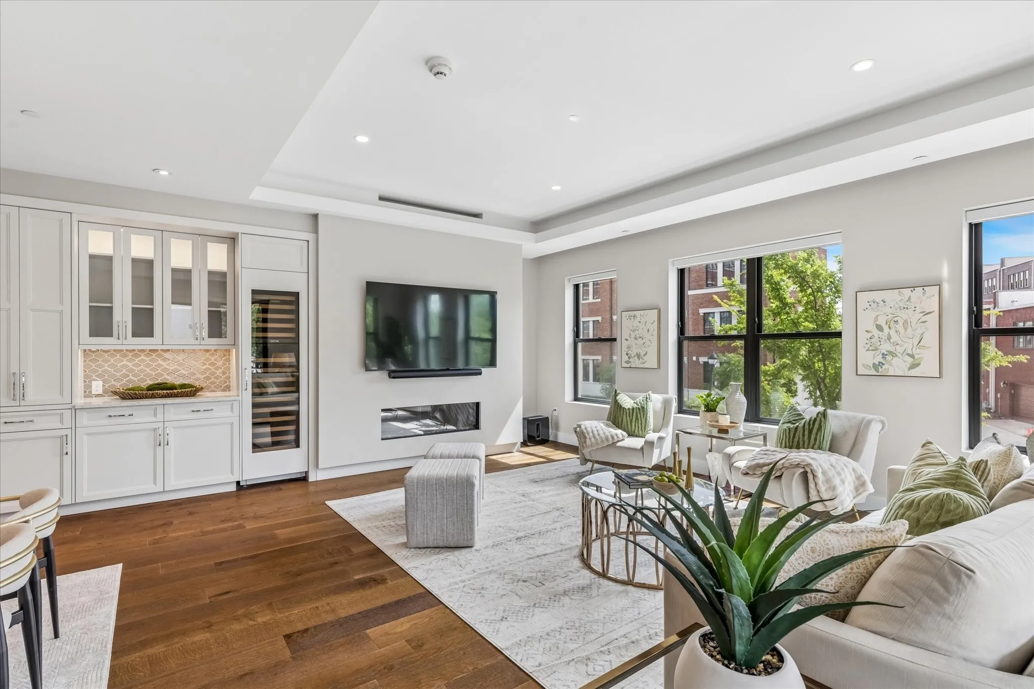 Mounted Flat Screen TV and Soundbar are included and will stay. Built-In Wine Fridge and fireplace add elegance and function.