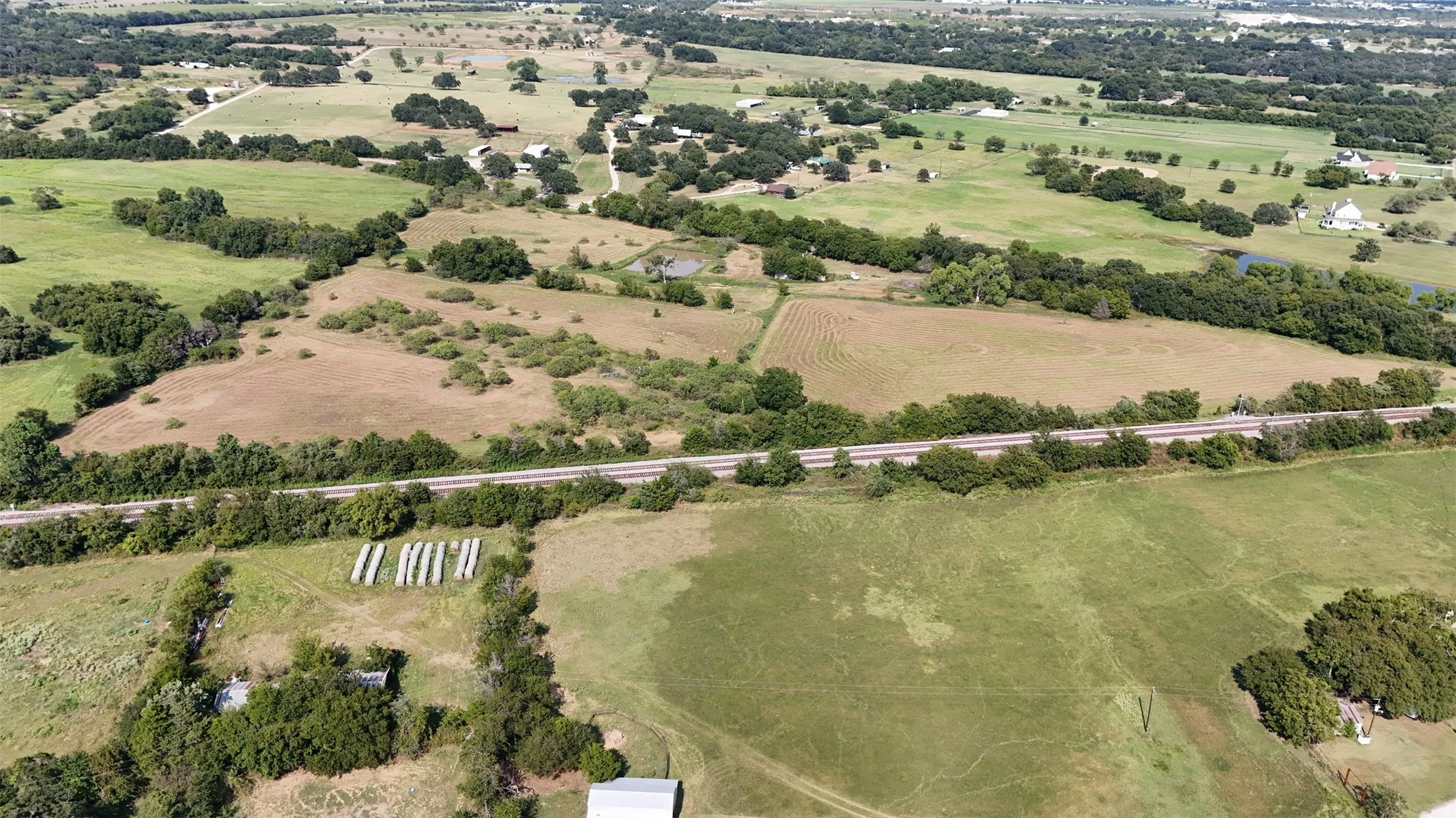 Aerial view of property's location with rural landscape and a tree filled landscape
