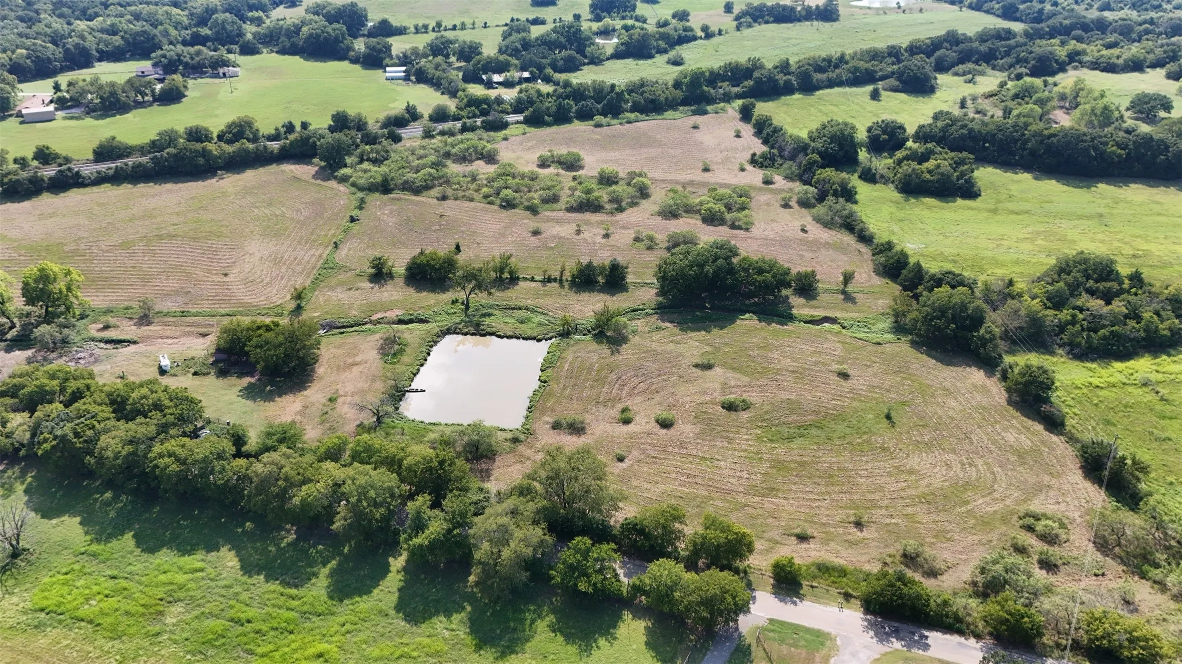 Overview of rural landscape featuring abundant farmland and a large body of water