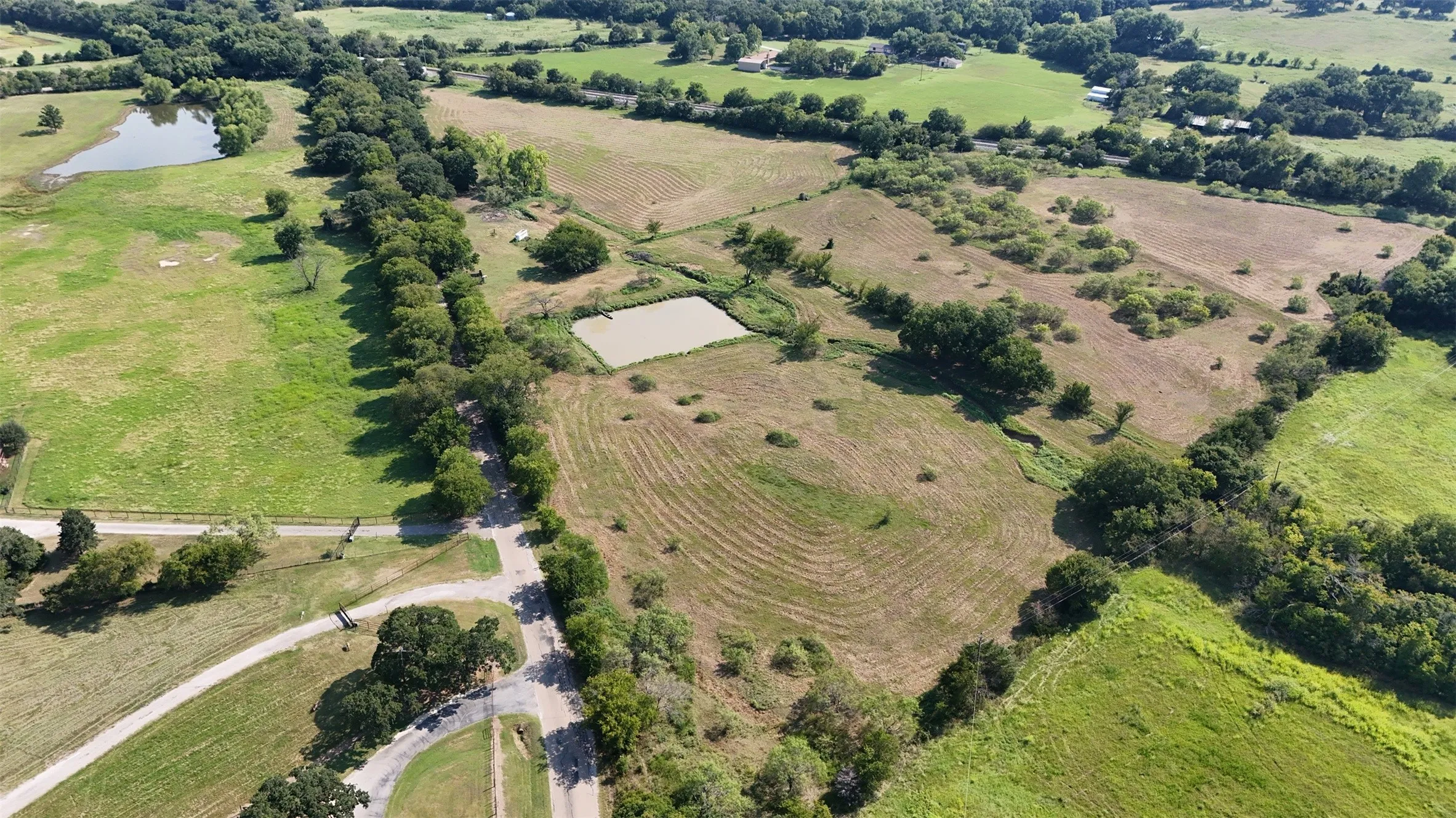 Aerial overview of property's location with rural landscape and extensive farmland