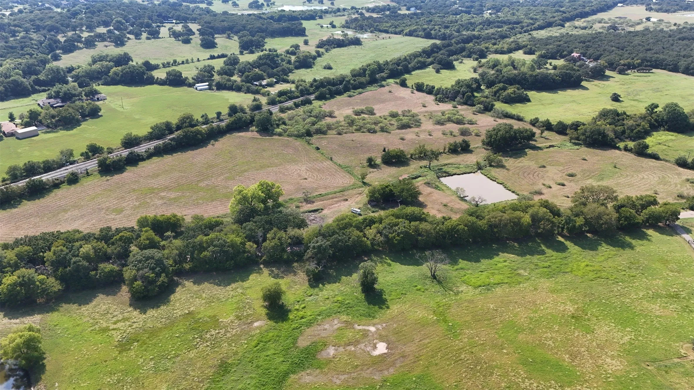 Aerial view of property's location with rural landscape and large plots for crops