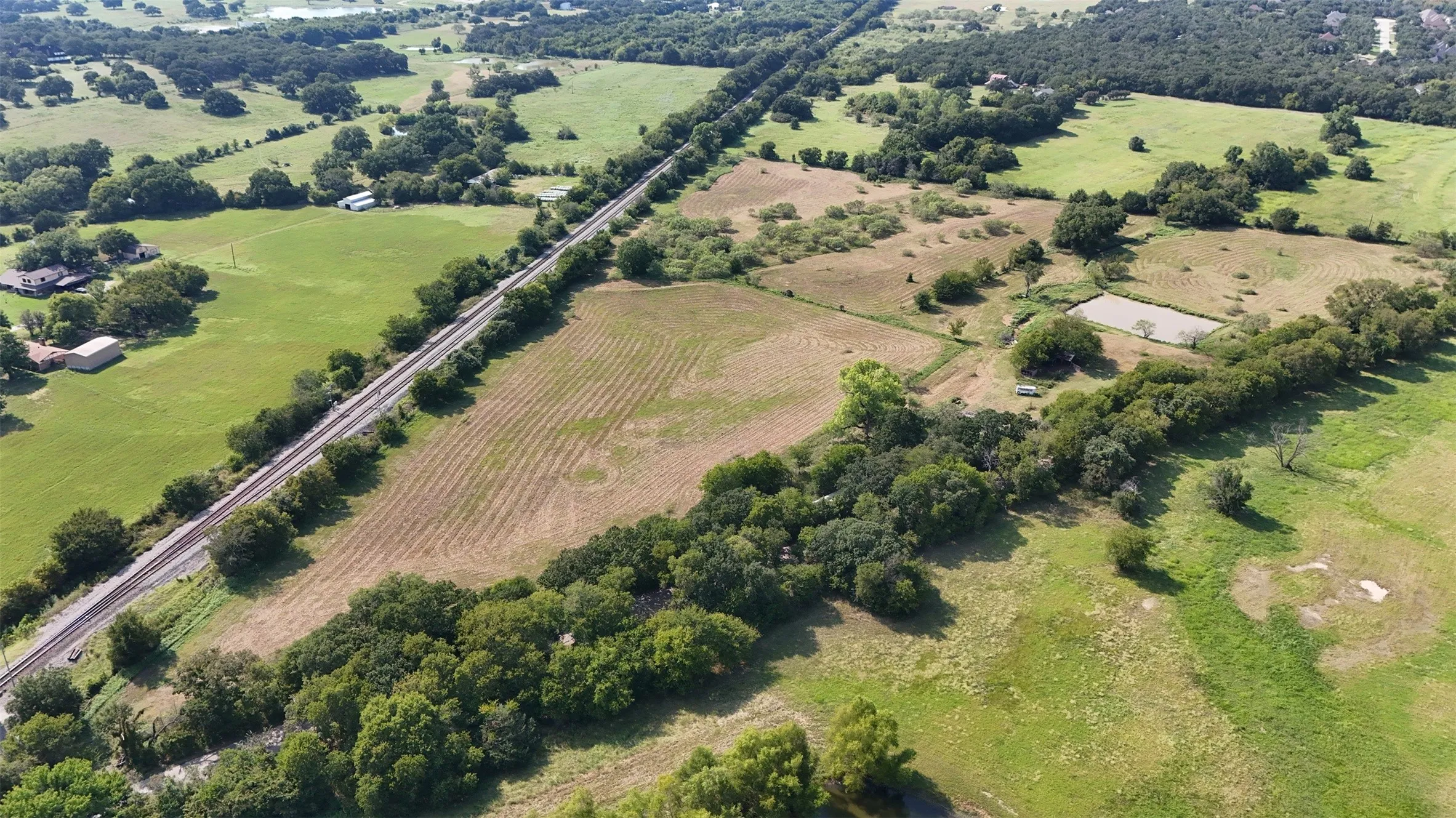 Aerial view of property's location featuring rural landscape and extensive farmland