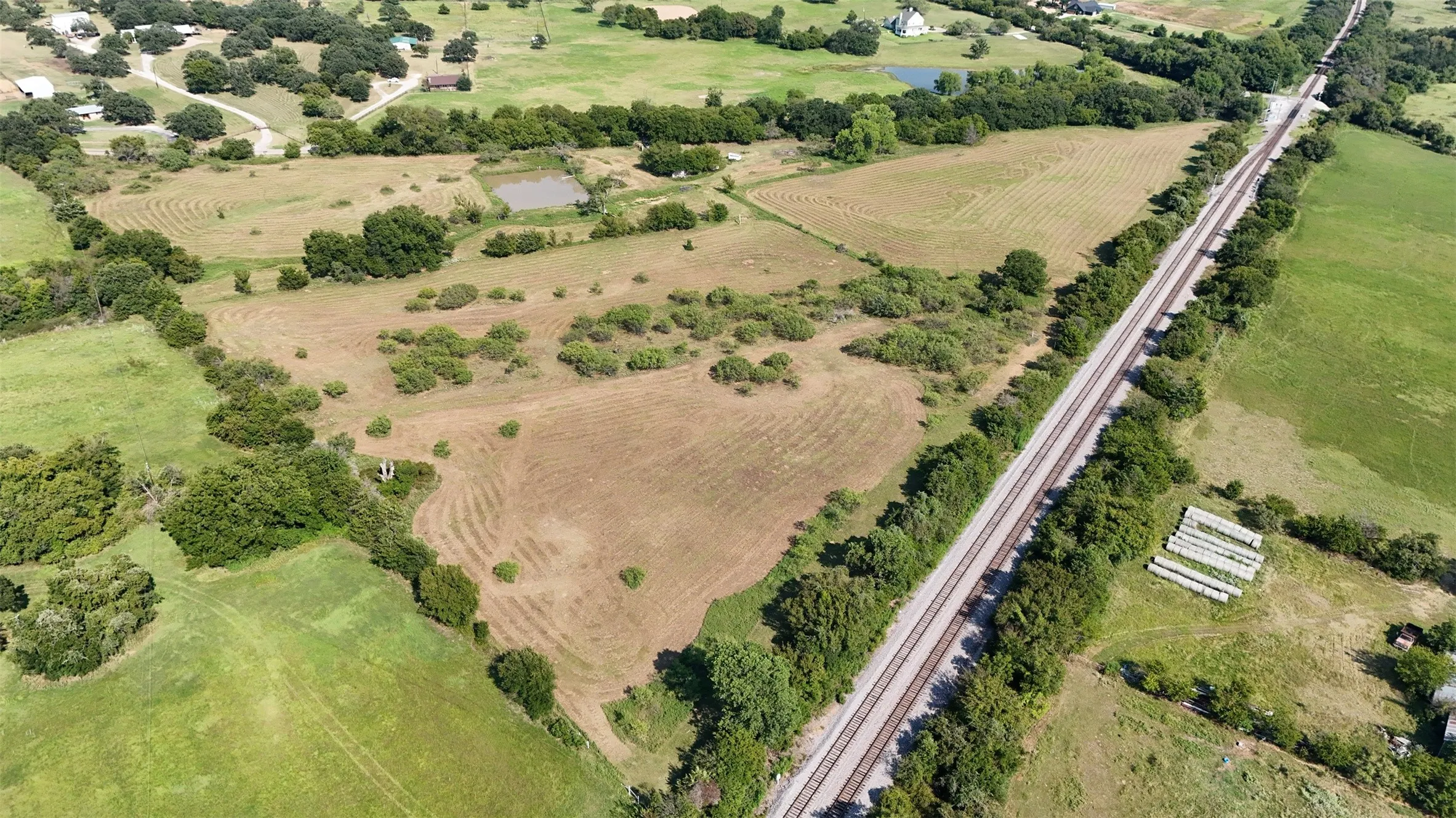 Aerial view of property and surrounding area featuring a large body of water and rural landscape