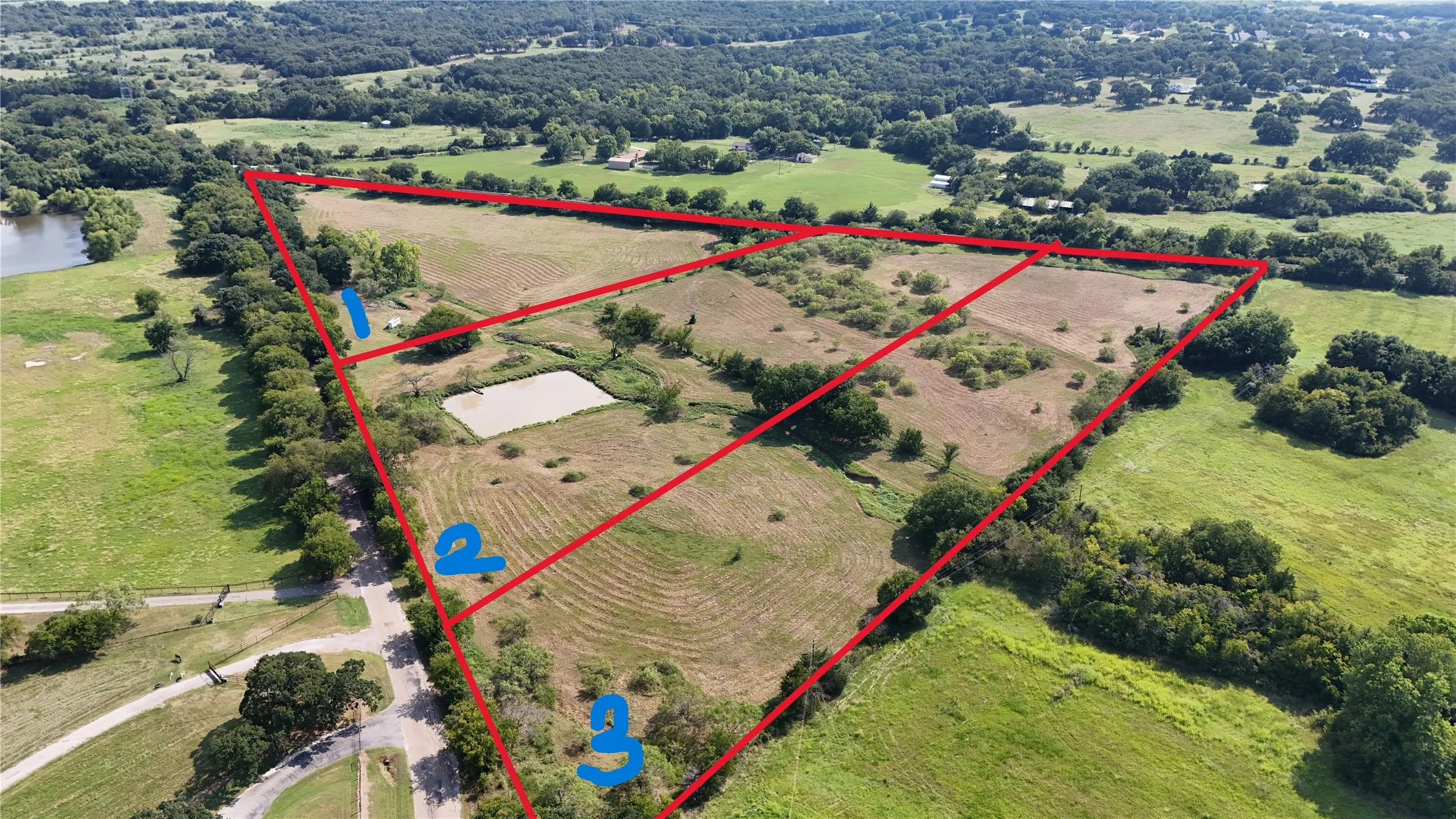 Aerial view of area with property parcel outlined and extensive farmland