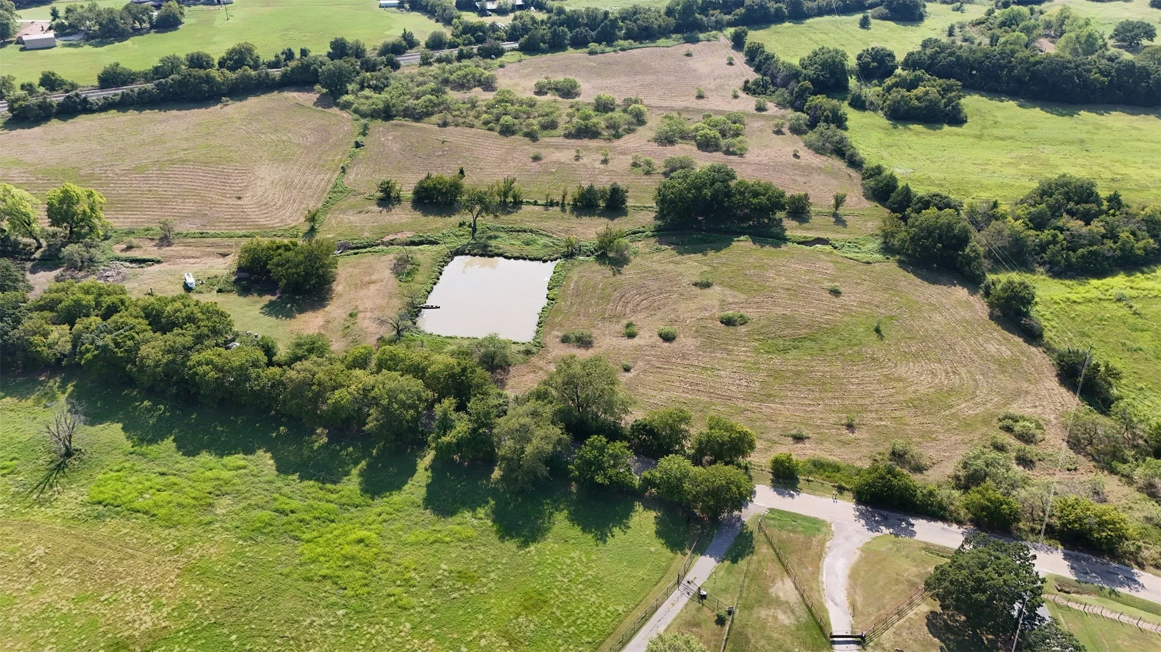 Aerial view of property's location with rural landscape and rows of crops