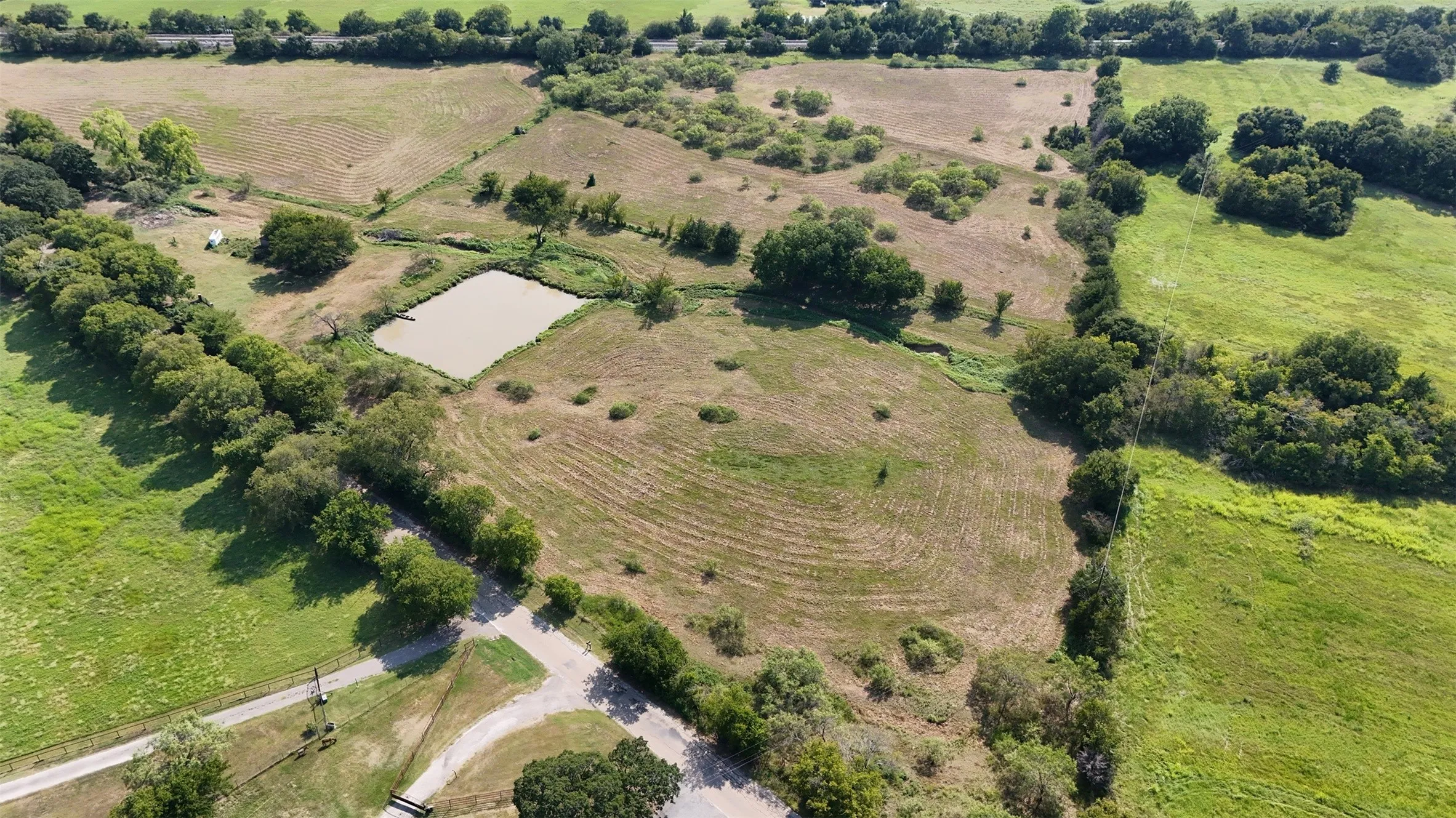 Aerial overview of property's location featuring rural landscape and large plots for crops