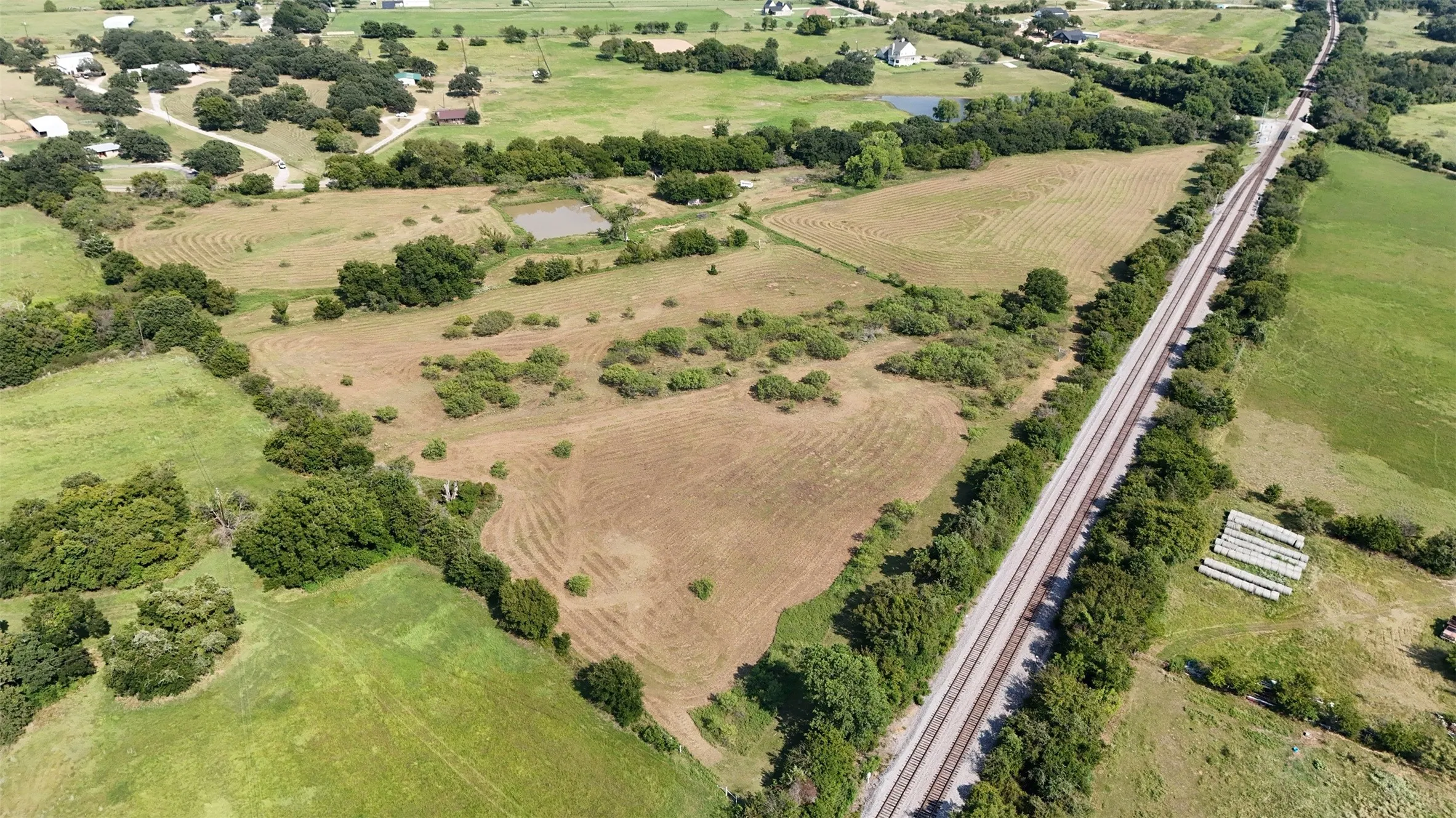 Aerial view of property's location featuring rural landscape and a nearby body of water